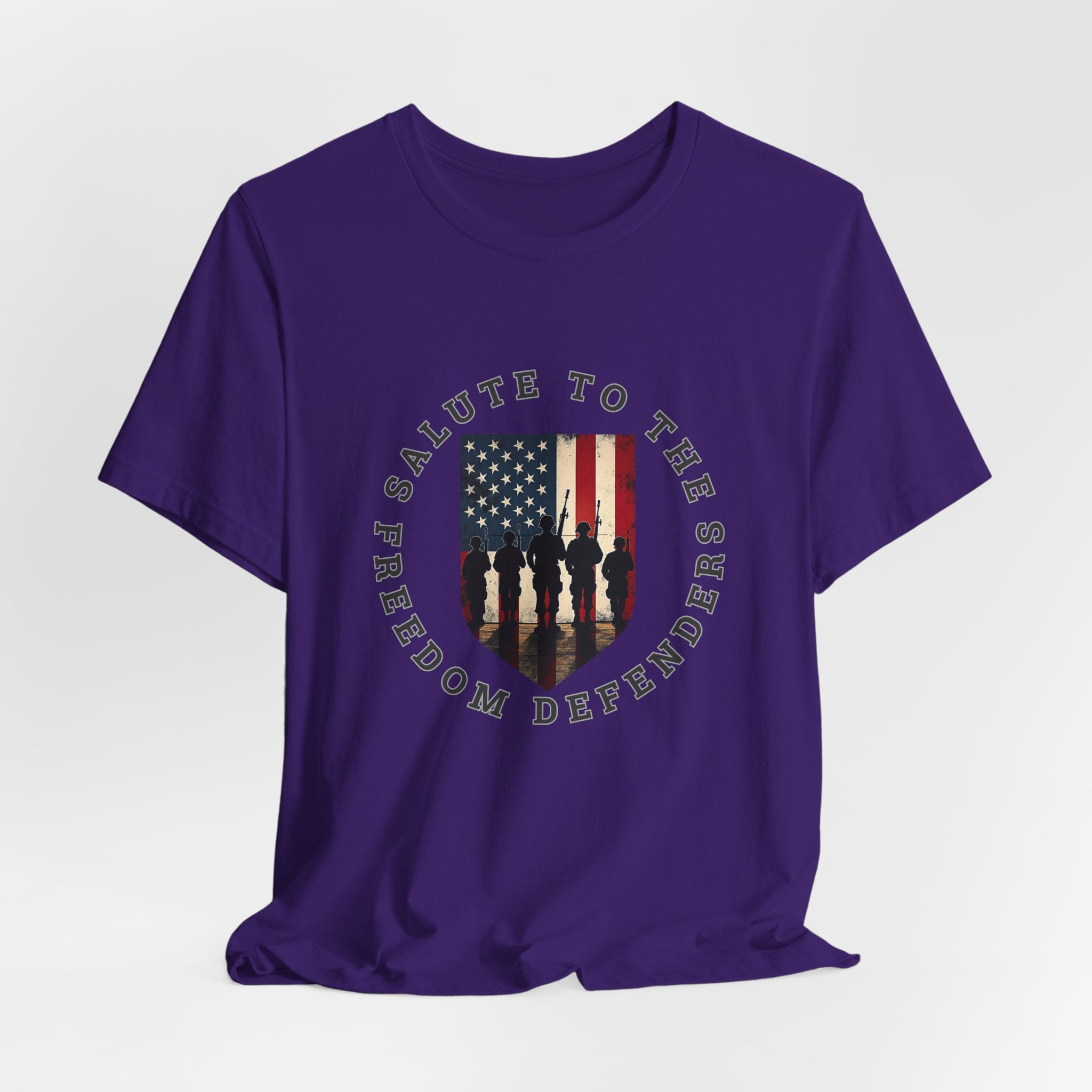 Team purple t-shirt with 'Salute to the Freedom Defenders' design featuring an American flag and silhouette of soldiers on a white background.
