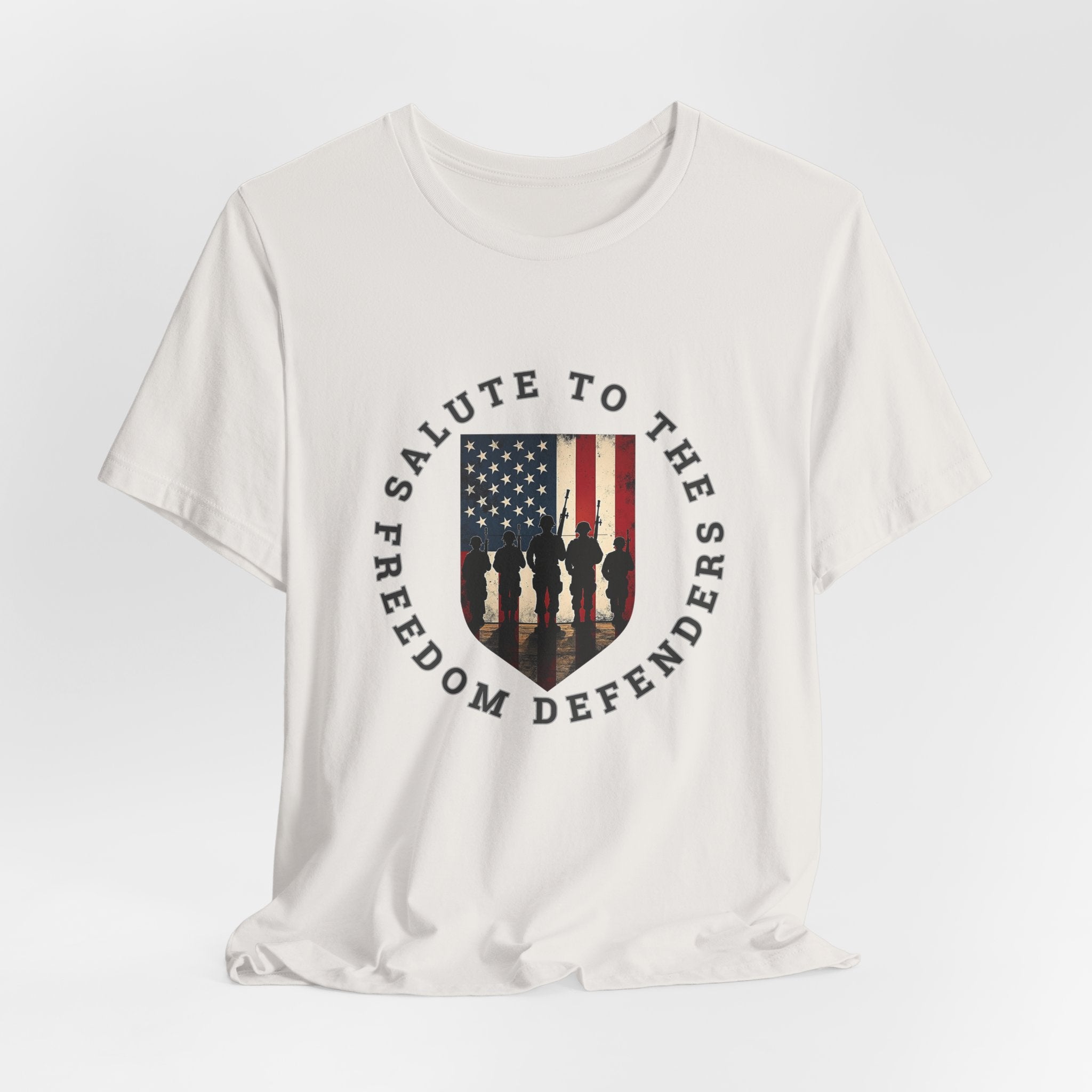 Vintage white t-shirt with 'Salute to the Freedom Defenders' design featuring an American flag and silhouette of soldiers on a white background.