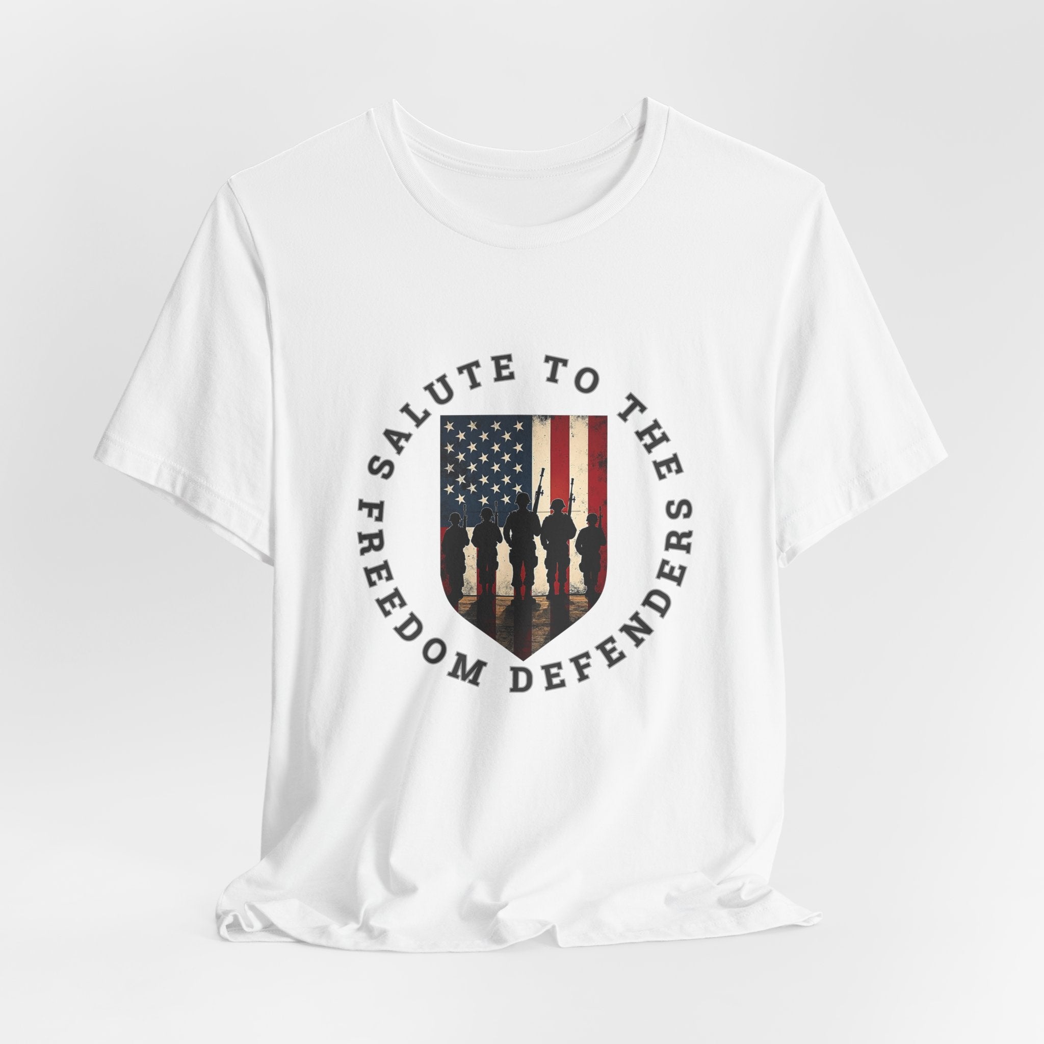 White t-shirt with 'Salute to the Freedom Defenders' design featuring an American flag and silhouette of soldiers on a white background.