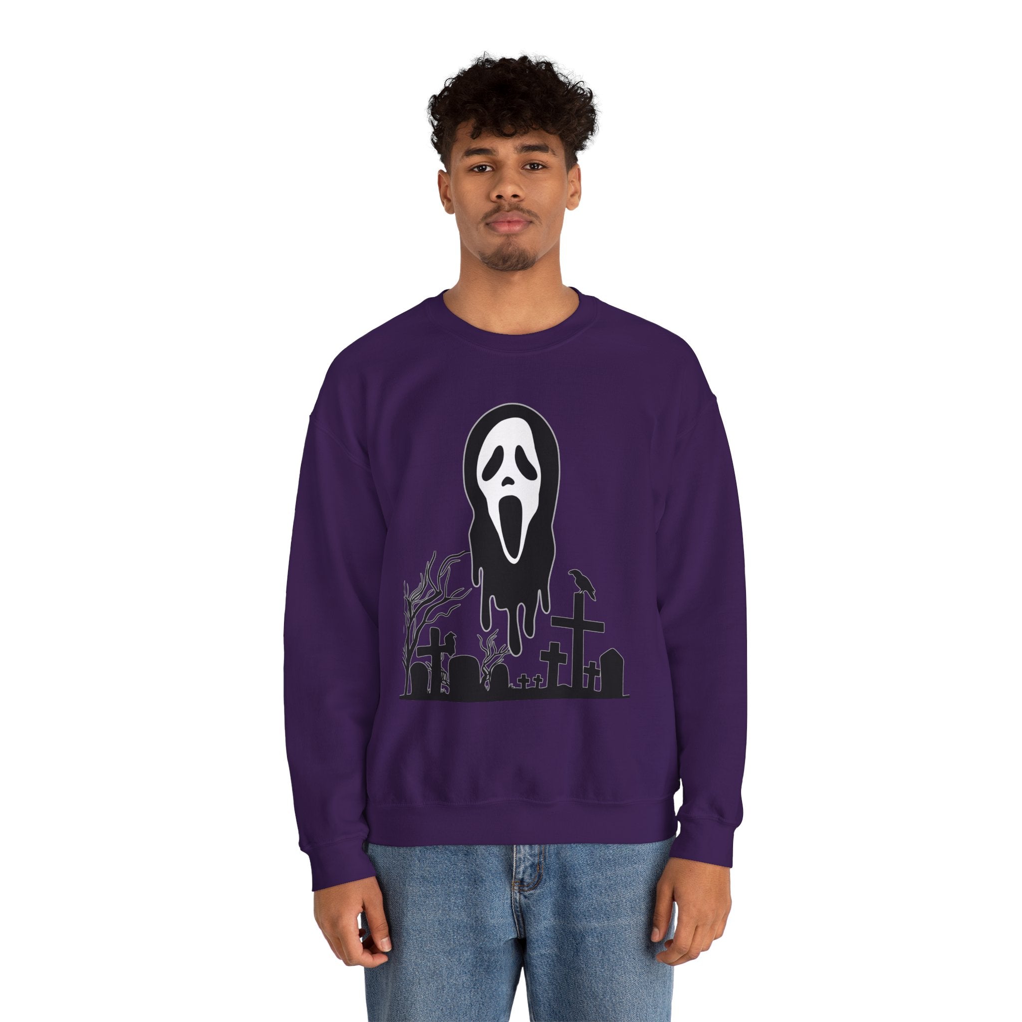 Person wearing a purple sweatshirt with a graphic design on a white background