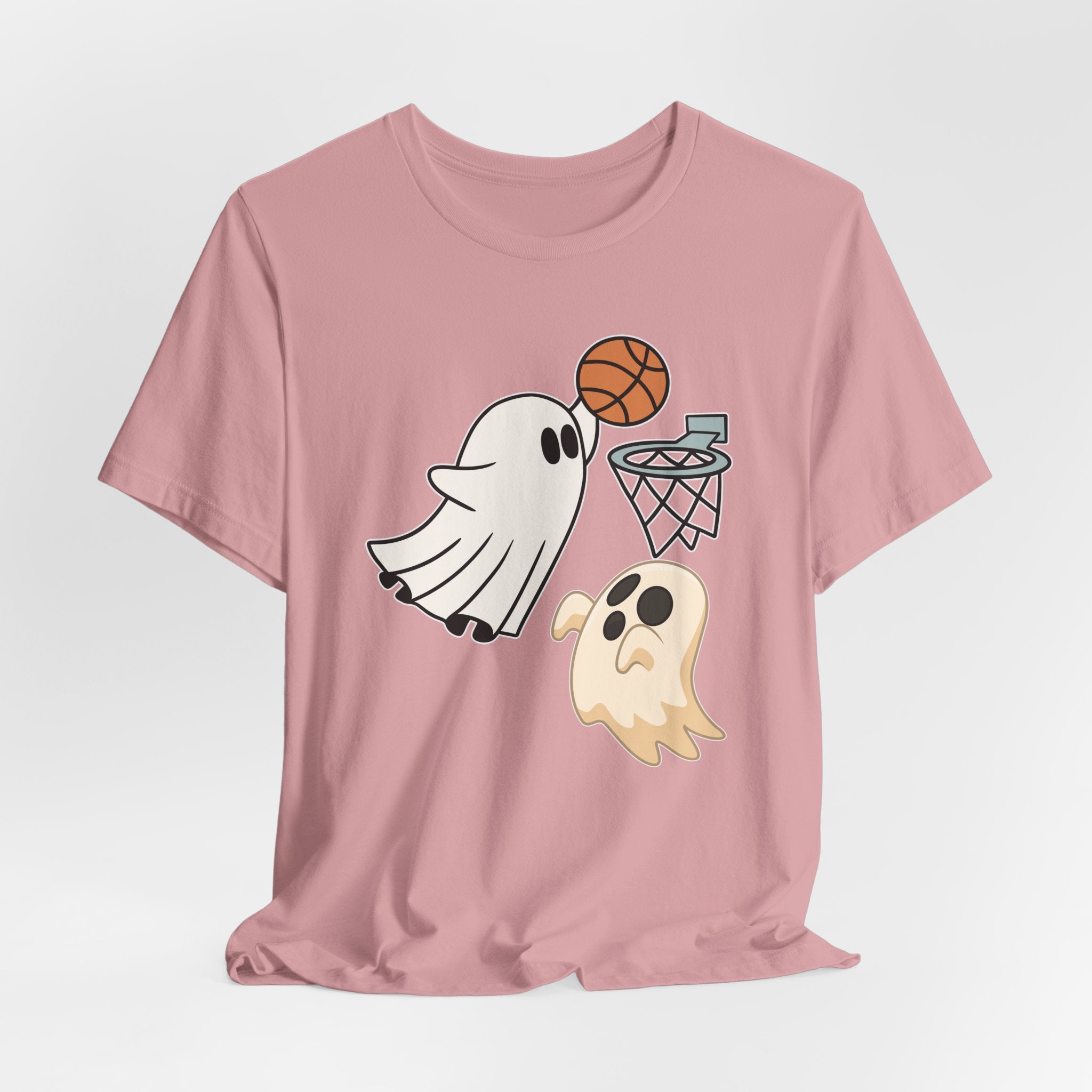 Orchid pink t-shirt featuring cute spooky halloween ghosts playing basketball design on a white background