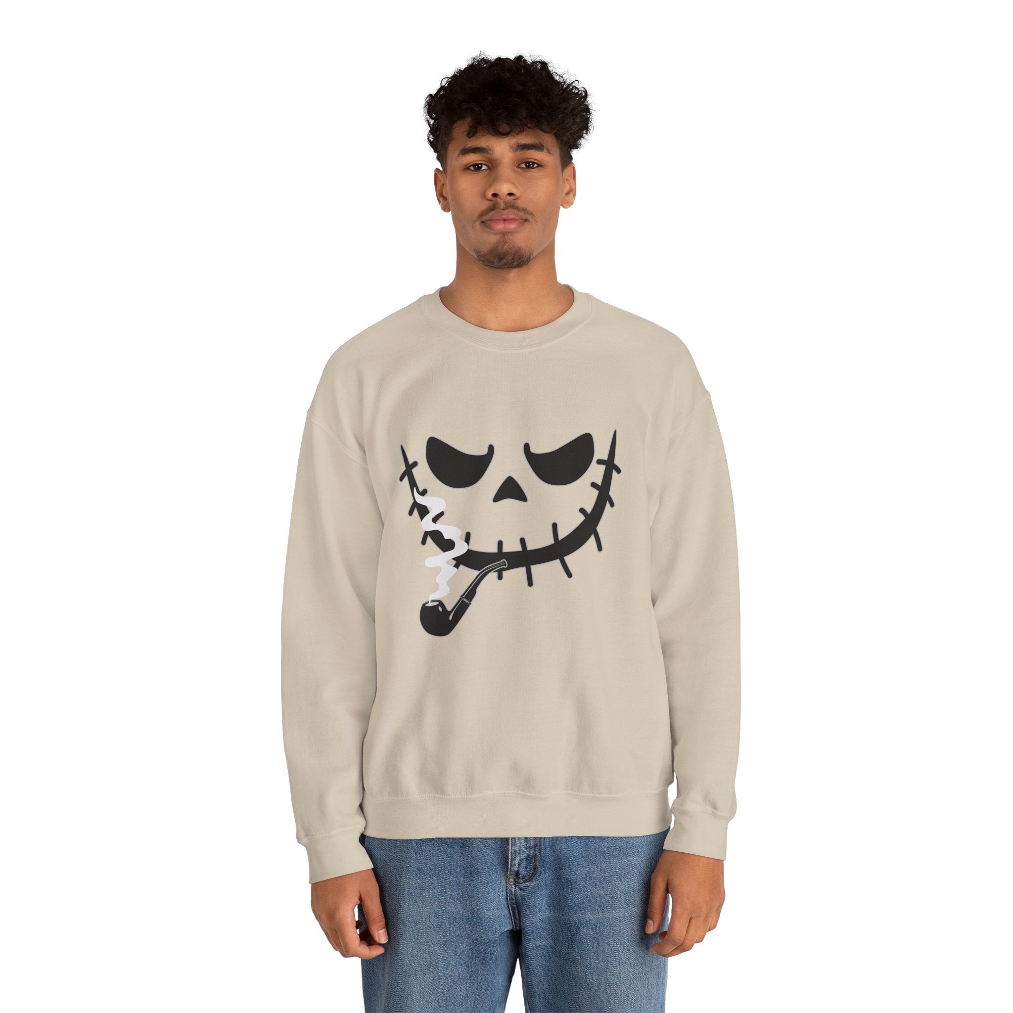 Person wearing a beige sweatshirt with a smoking monster skull design on a white background