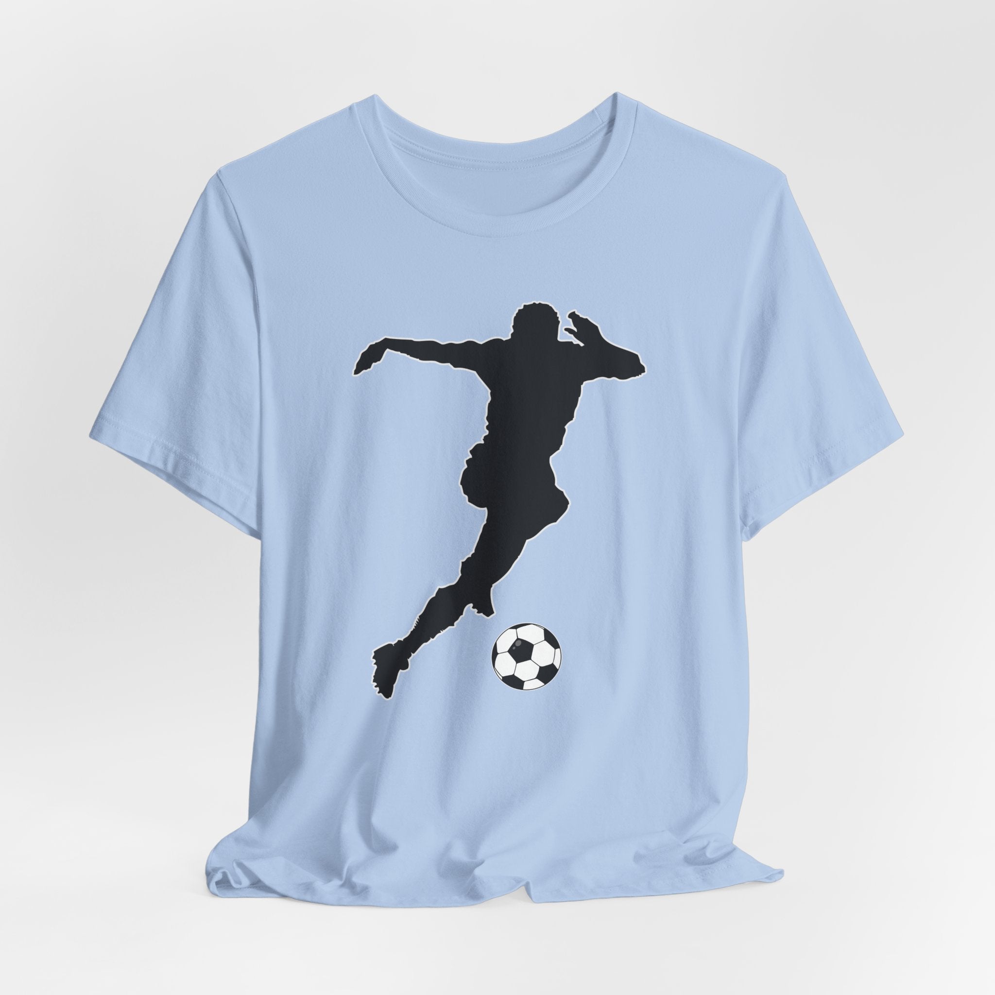 Baby blue t-shirt with a black silhouette of a soccer player kicking a ball on a light gray background