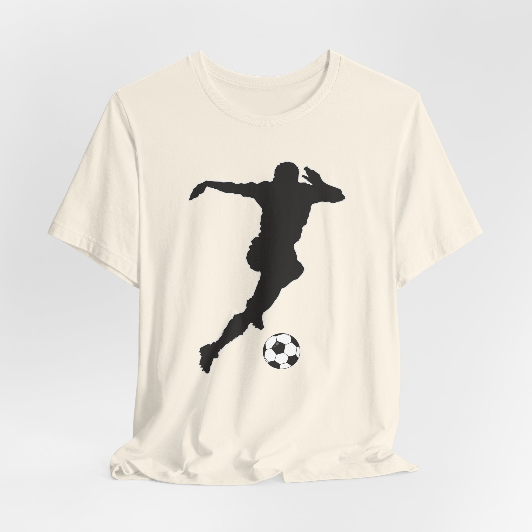 Beige t-shirt with a black silhouette of a soccer player and ball on a light gray background