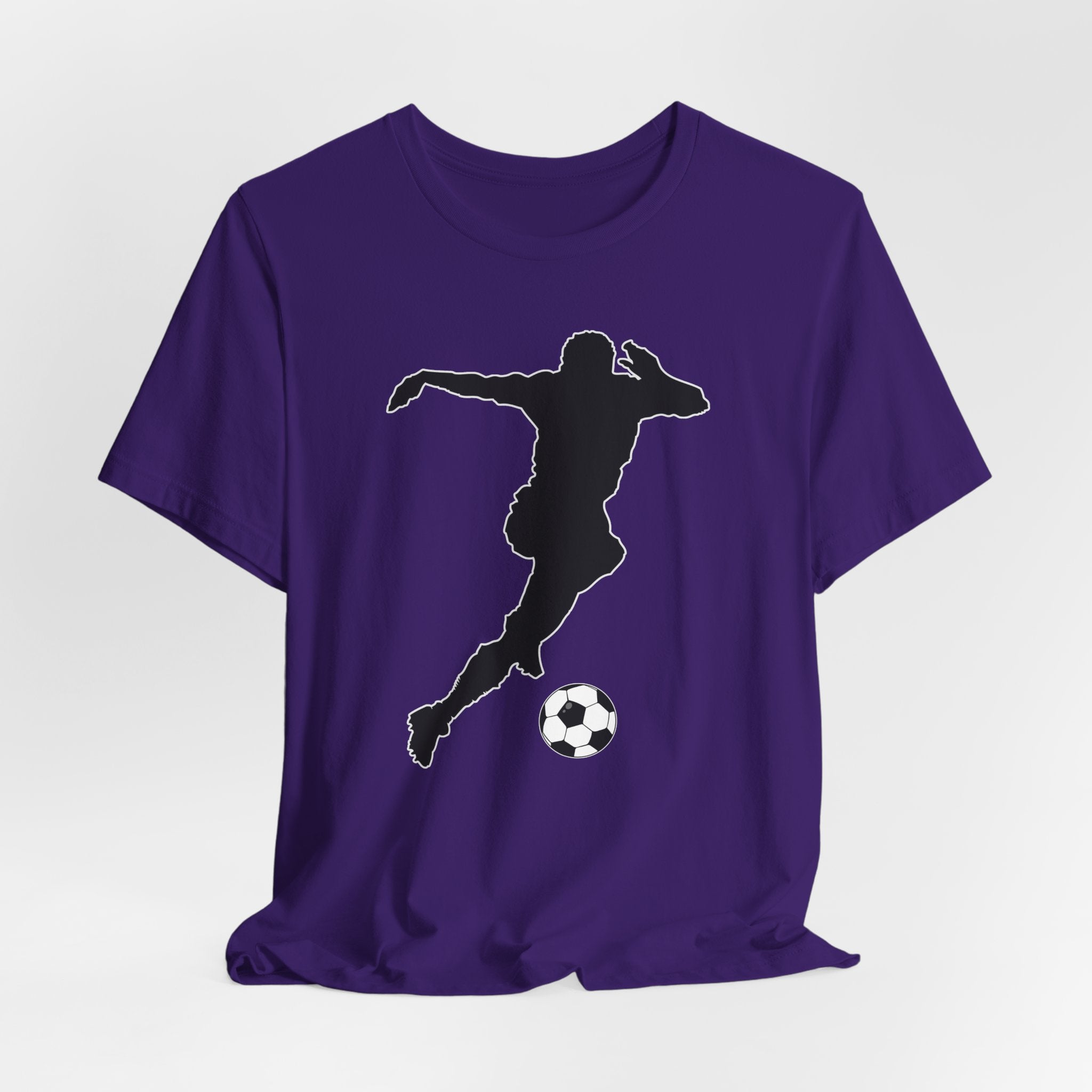 Purple t-shirt with a black silhouette of a soccer player kicking a ball on a white background