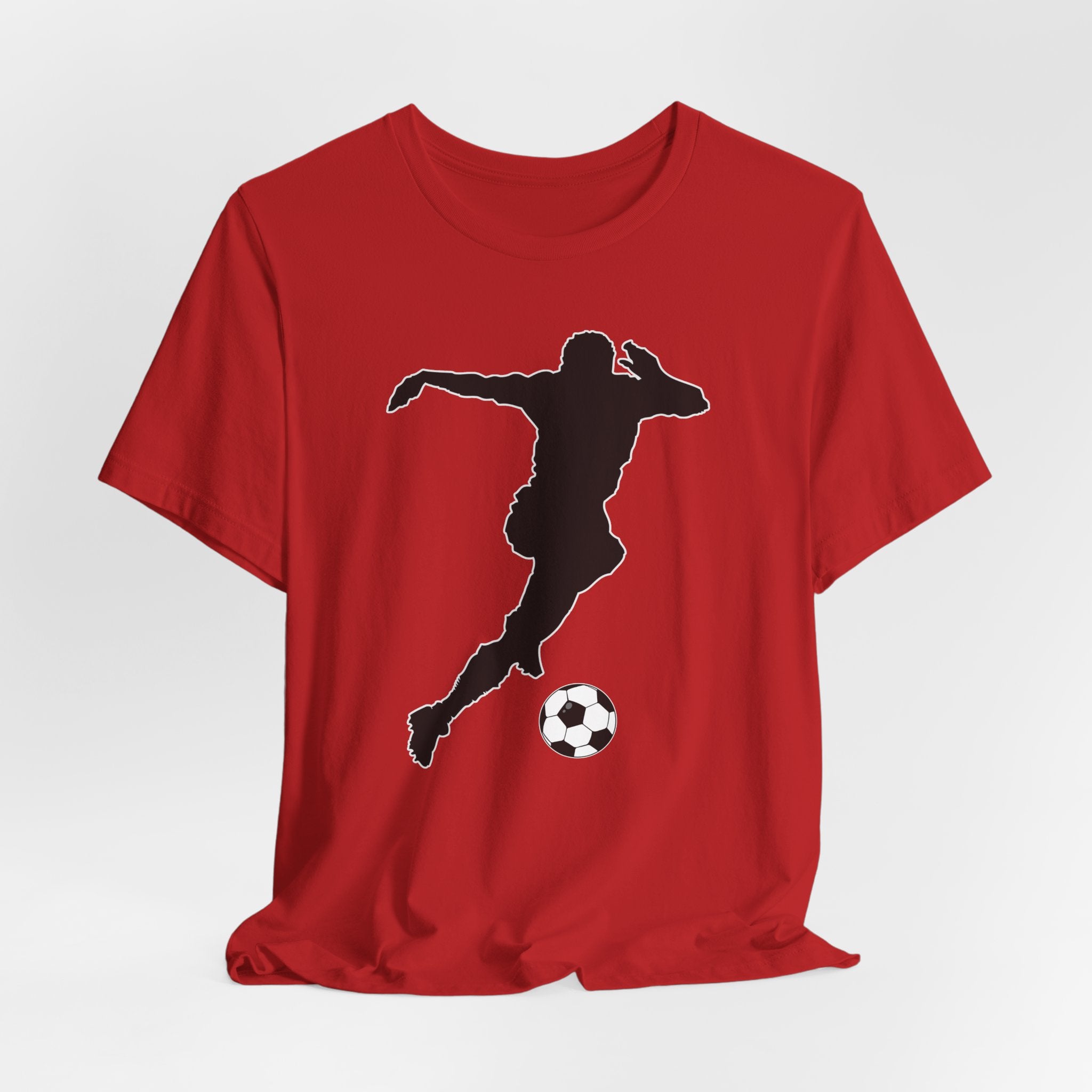 Red t-shirt with a black silhouette of a soccer player kicking a ball on a white background