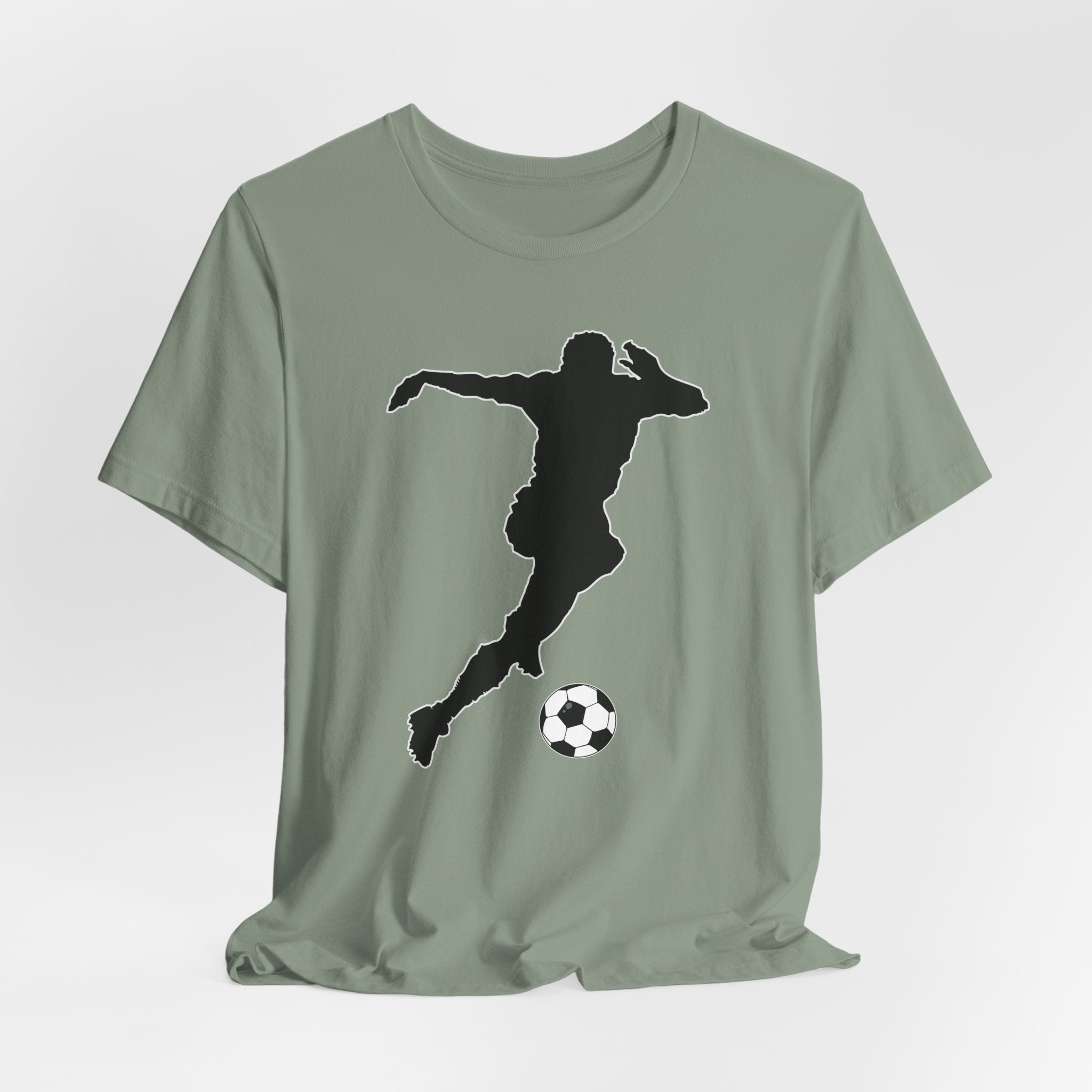 Sage green t-shirt with a black silhouette of a soccer player kicking a ball on a white background