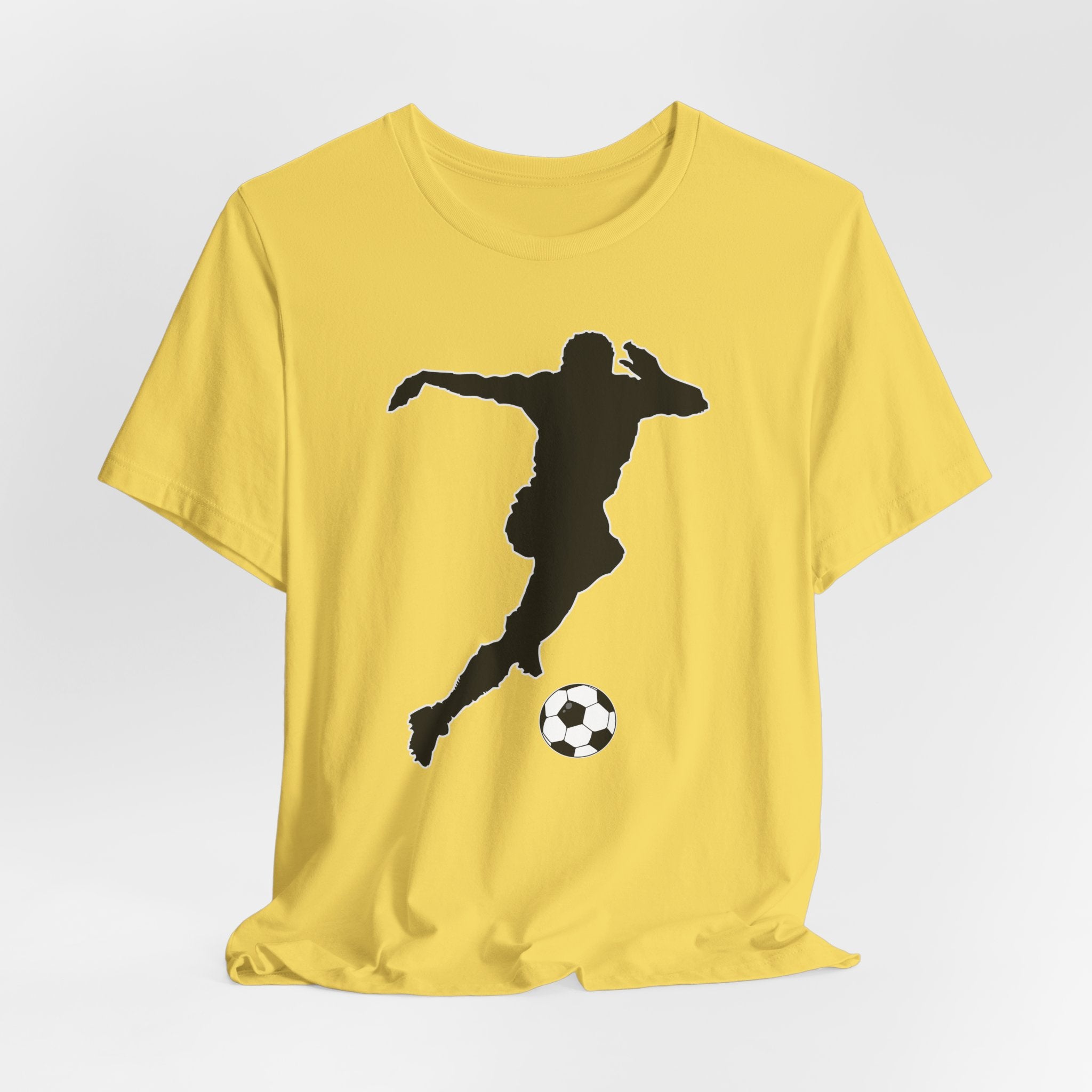 Yellow t-shirt with a black silhouette of a soccer player kicking a ball on a white background