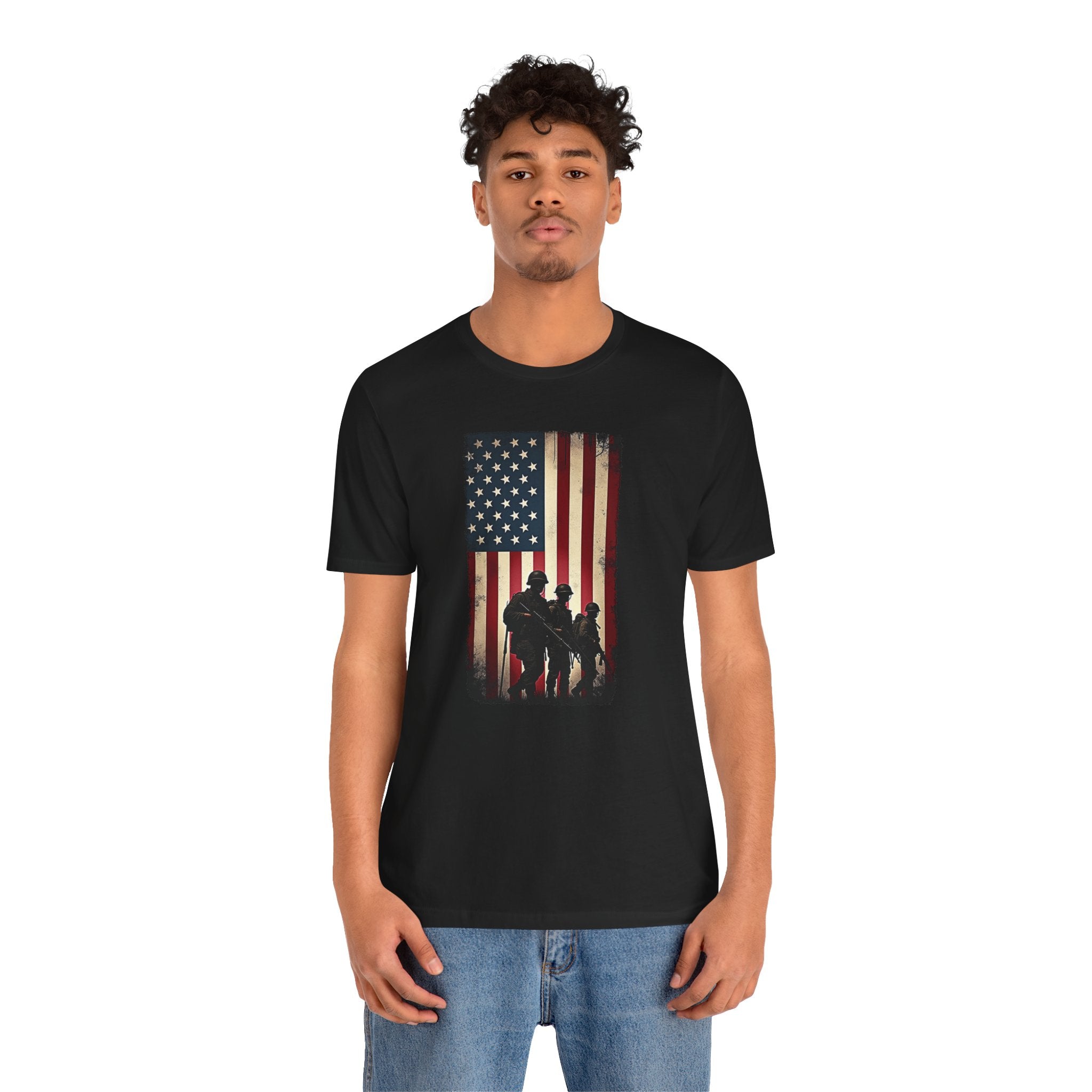 Person wearing a black t-shirt with an American flag and silhouette design on a white background