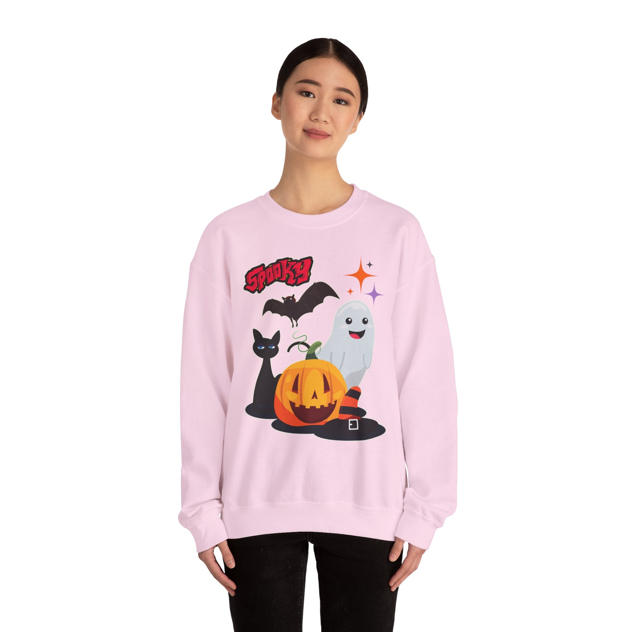 Person wearing a pink sweatshirt with Halloween-themed graphics on a white background