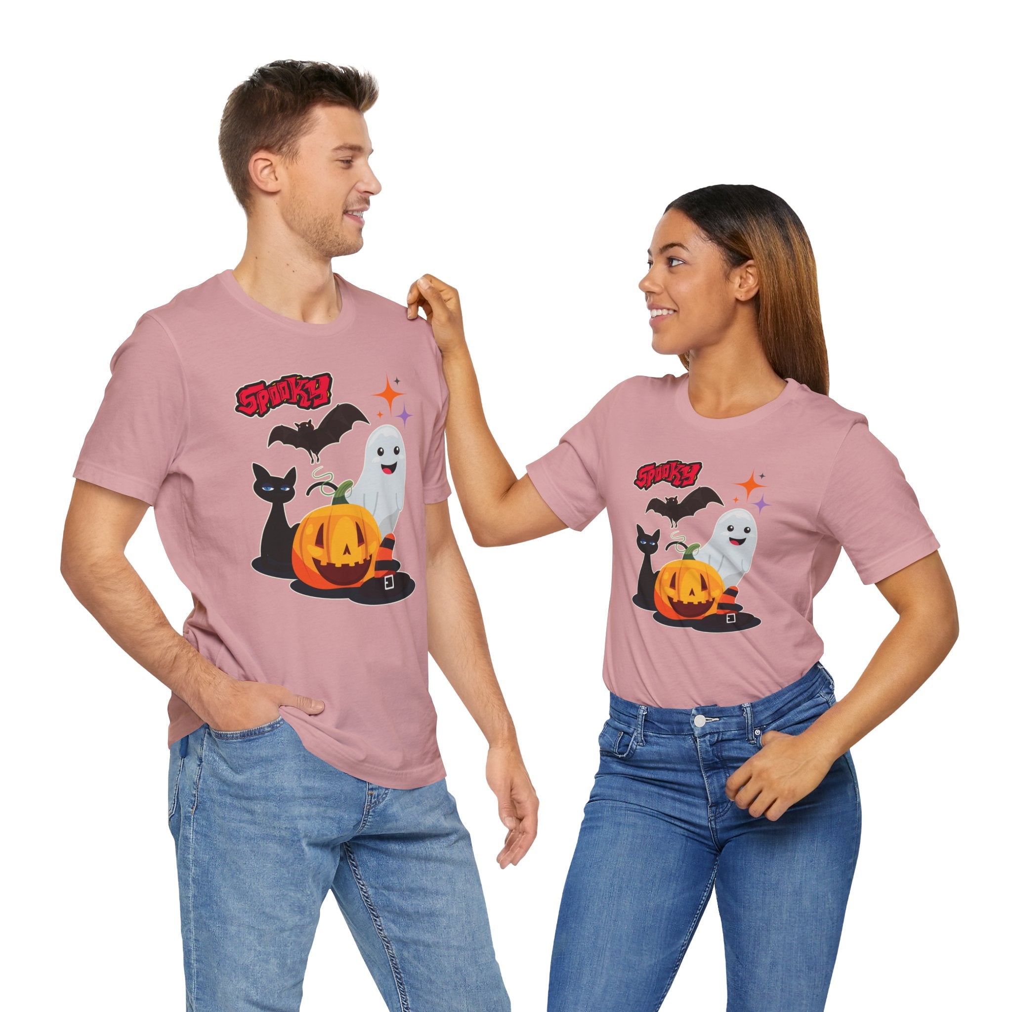 Two people wearing matching pink t-shirts with Halloween designs on a white background