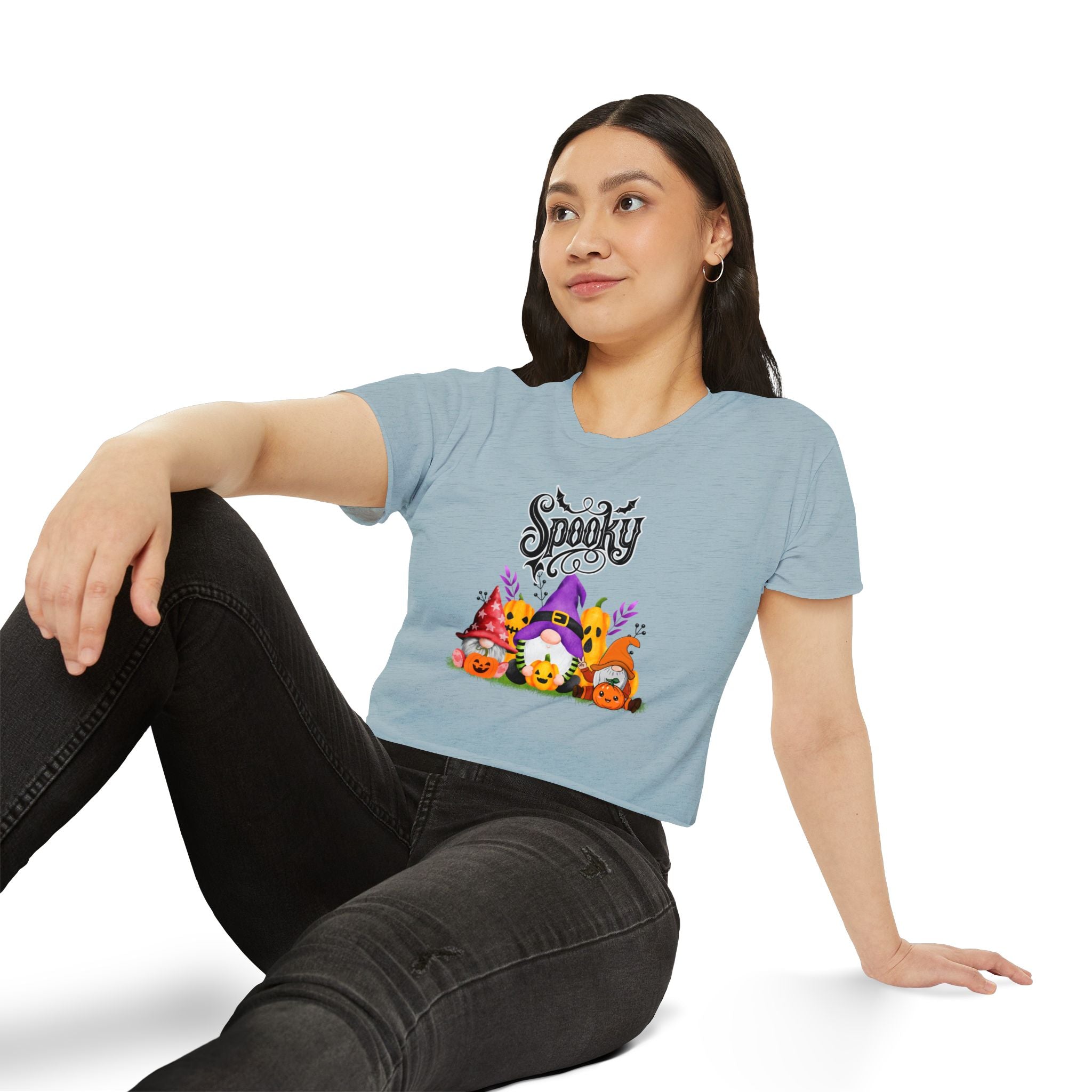 Woman wearing a light blue t-shirt with Halloween-themed design and text.