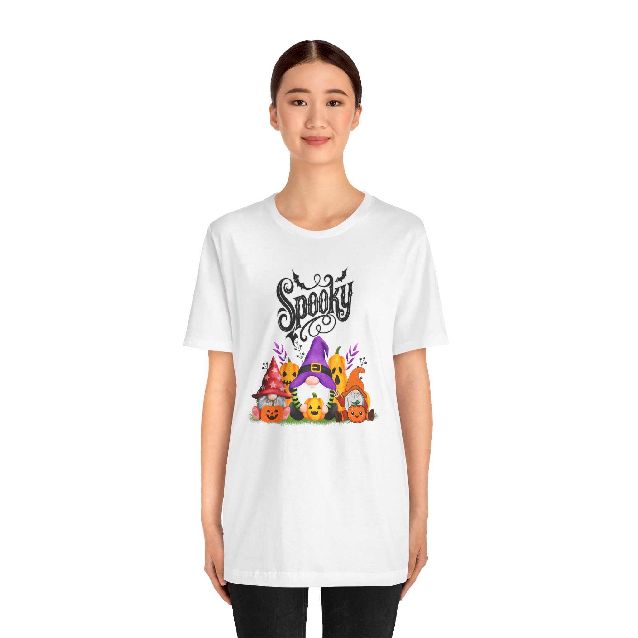 Person wearing a white t-shirt with Halloween-themed design and text.