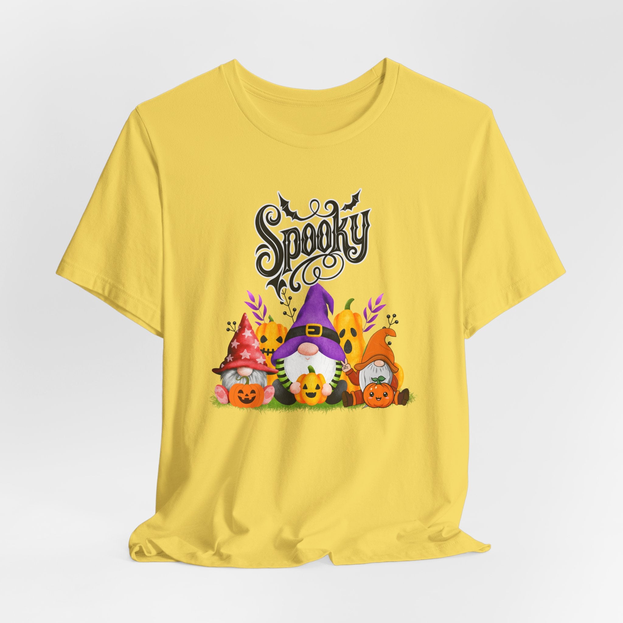 Maze yellow t-shirt with Halloween-themed design featuring spooky gnomes and pumpkins on a white background