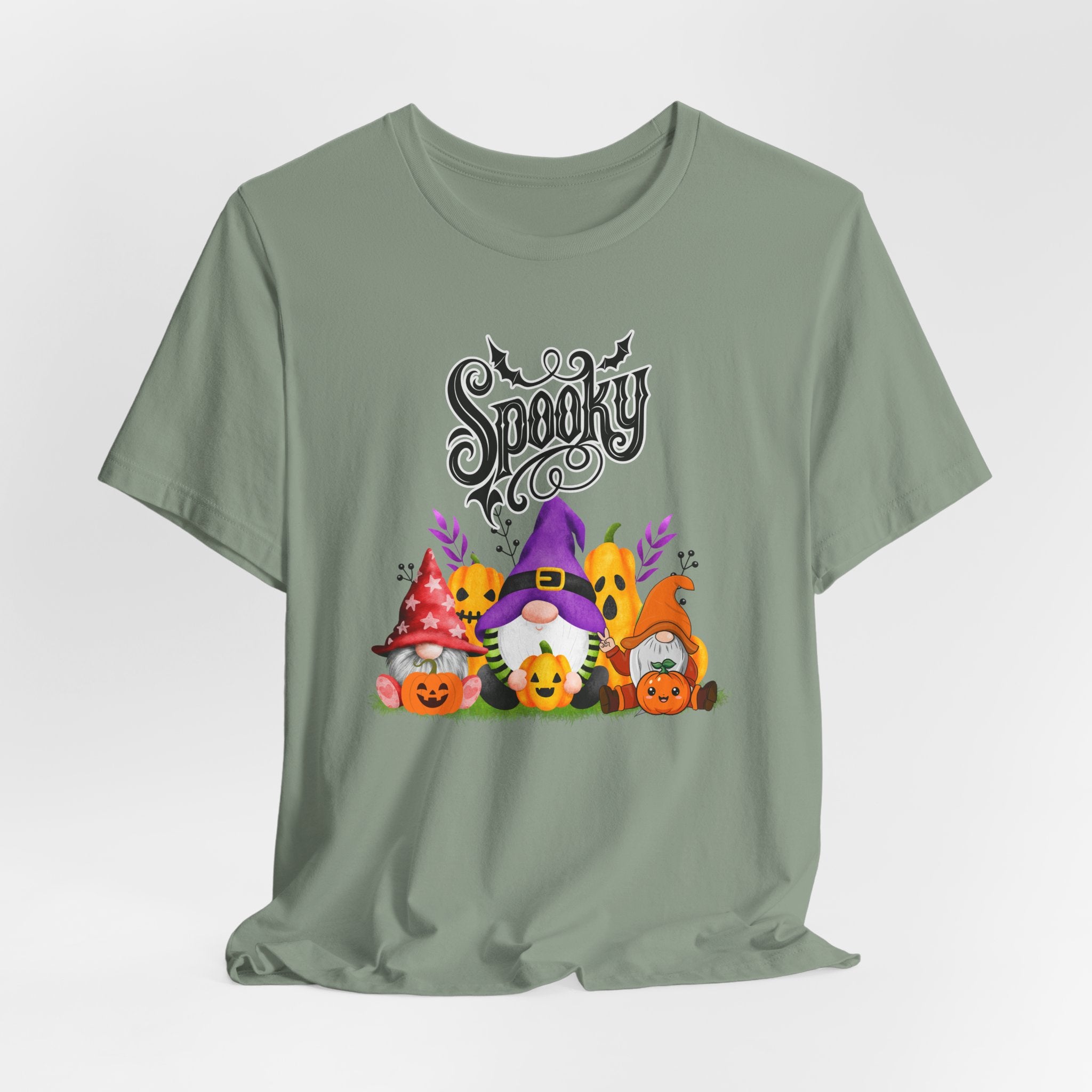 Sage green t-shirt with Halloween-themed design featuring spooky gnomes and pumpkins on a white background