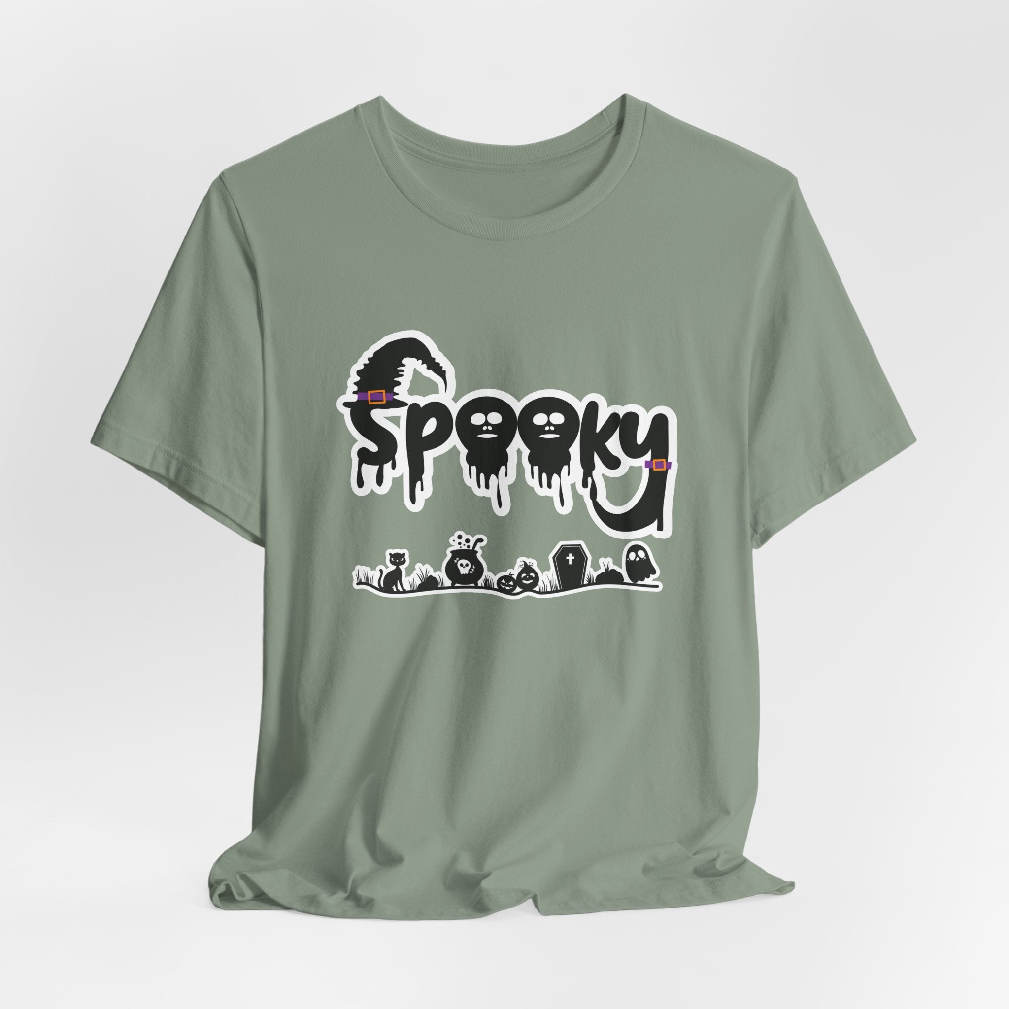 Sage green t-shirt with 'Spooky' halloween ghost, pumpkins, cat, and witch graphic design on a white background