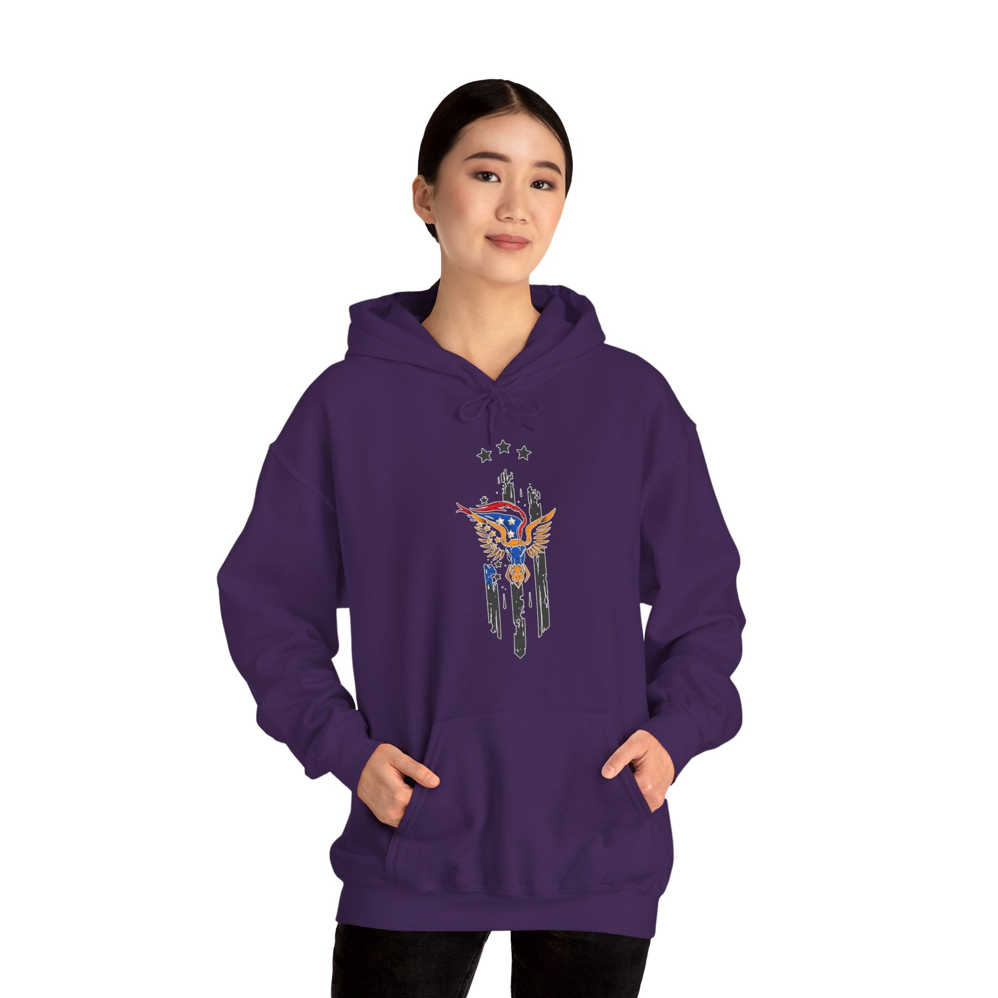 Person wearing a purple hoodie with a graphic design of bull and wing with stars on a white background