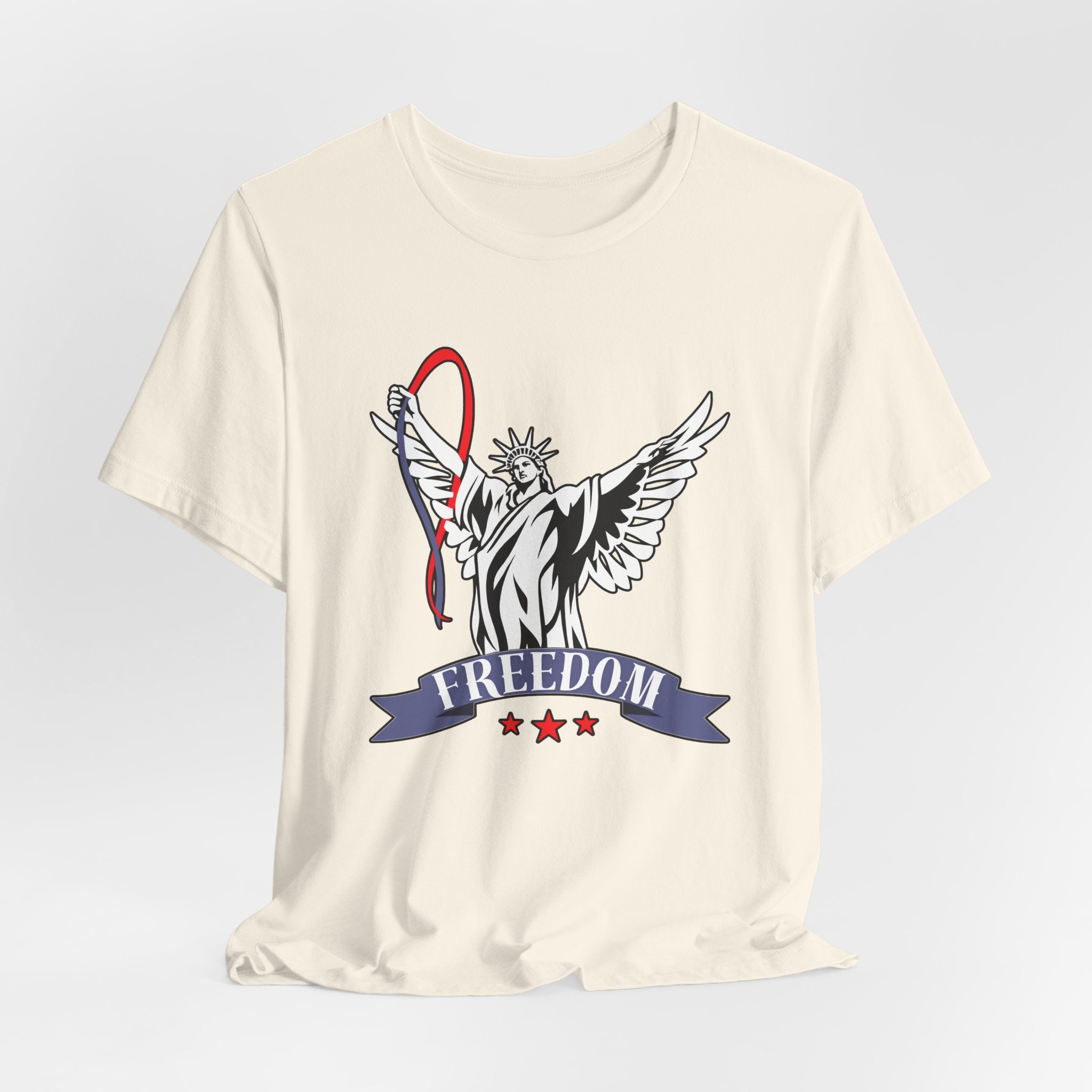 Ivory beige t-shirt with a graphic design of the Statue of Liberty holding a banner with 'Freedom' on a light gray background.