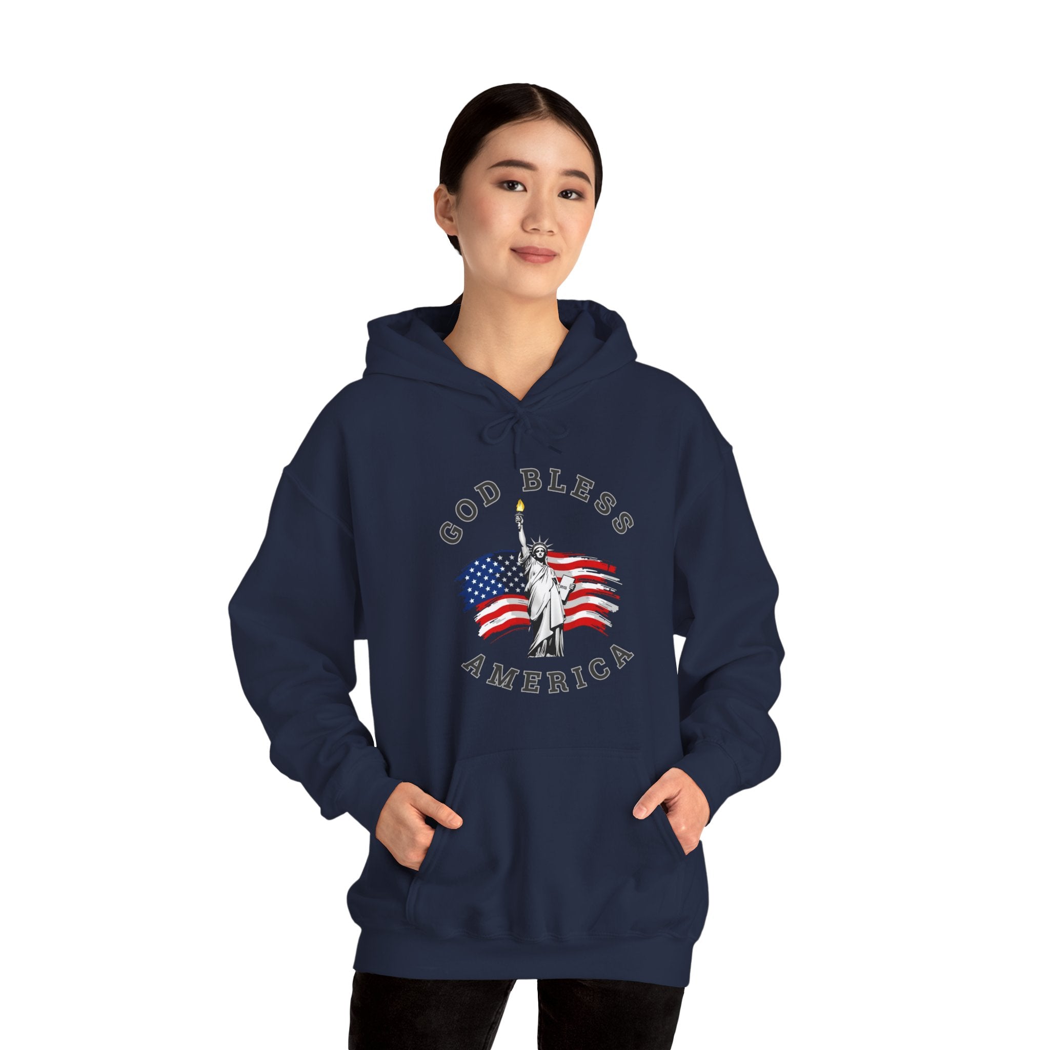 Navy blue hoodie with 'God Bless America' design featuring the Statue of Liberty and American flag, worn by a person on a white background.