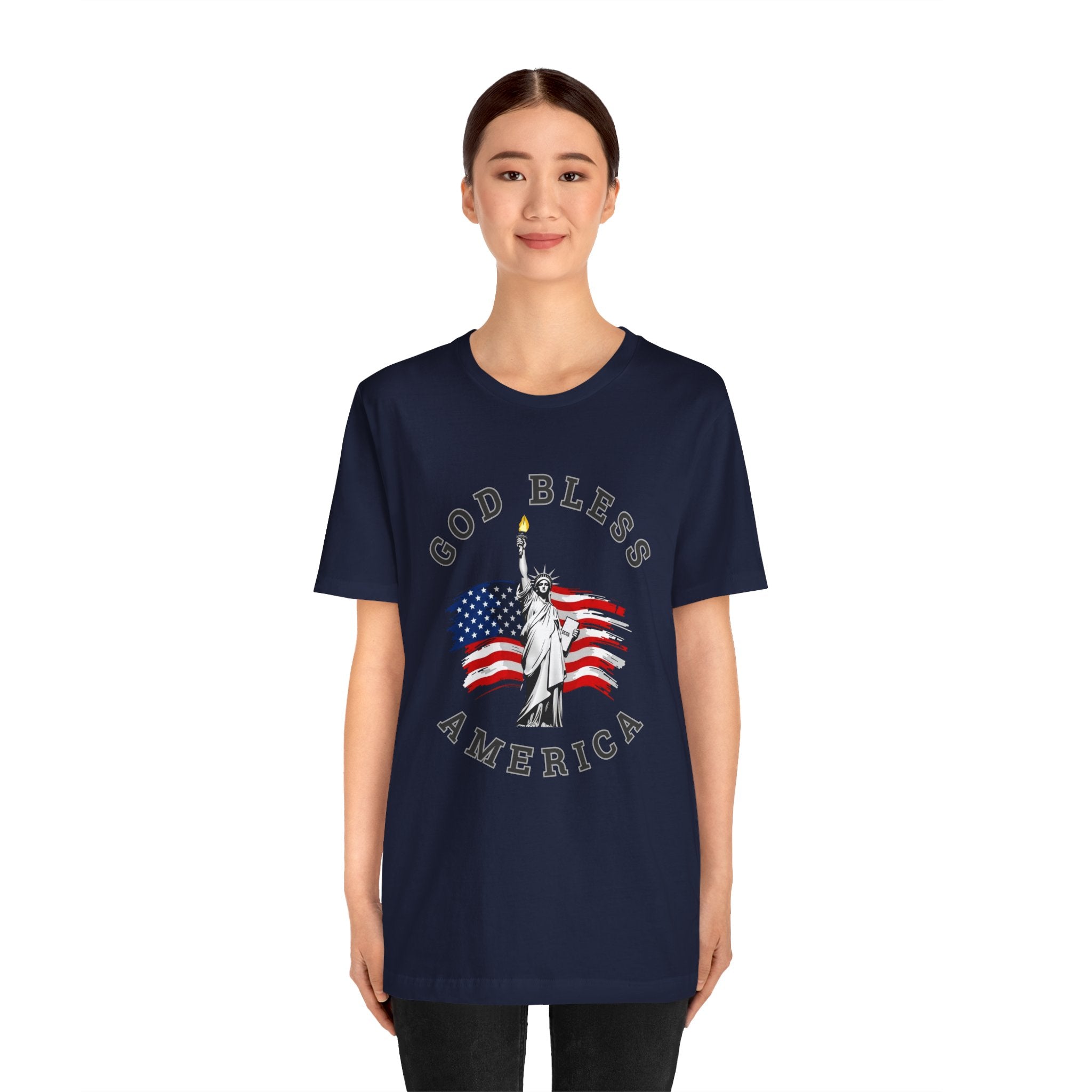 Person wearing a navy blue t-shirt with 'God Bless America' design featuring the Statue of Liberty and American flag.