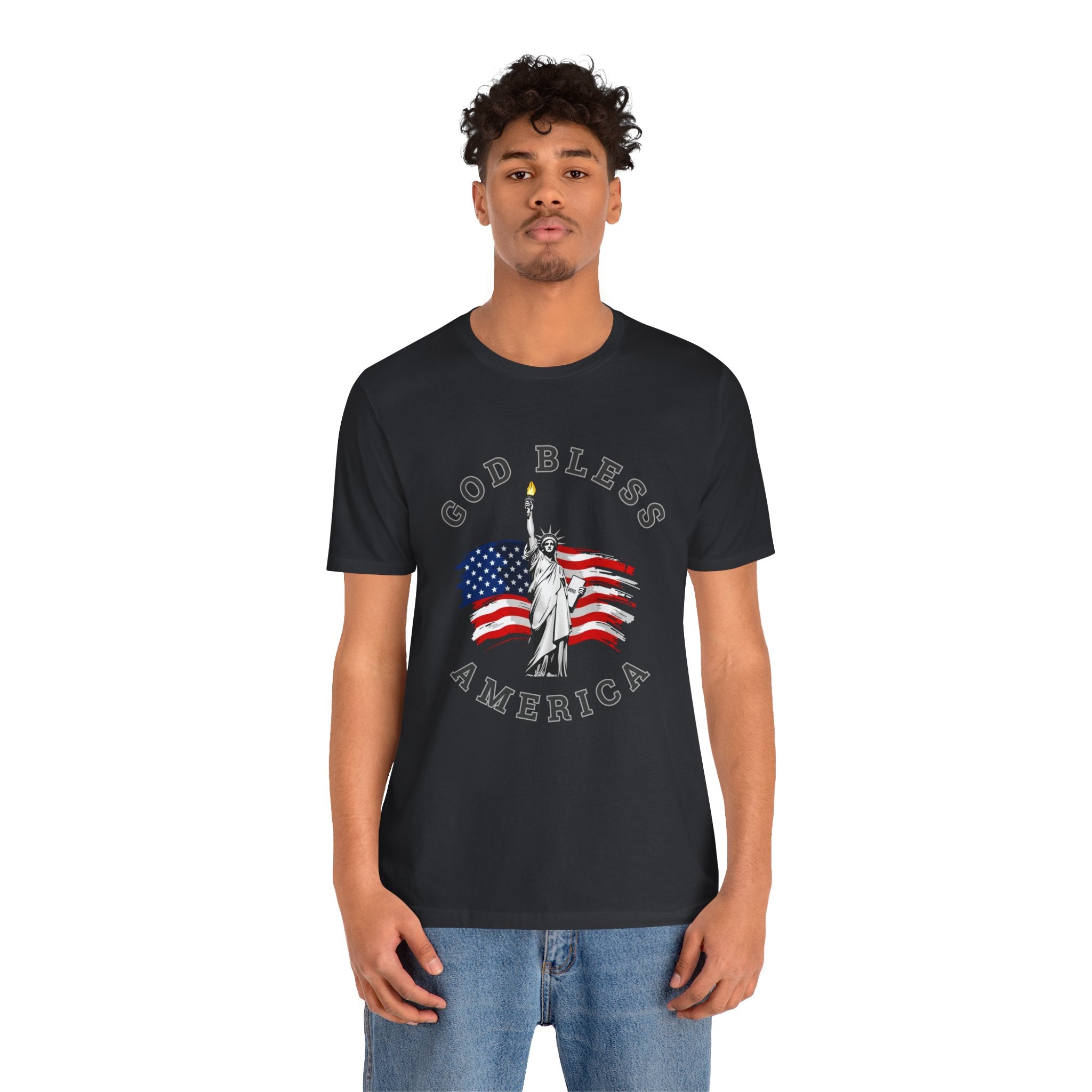 Person wearing a black t-shirt with 'God Bless America' and Statue of Liberty design on a white background