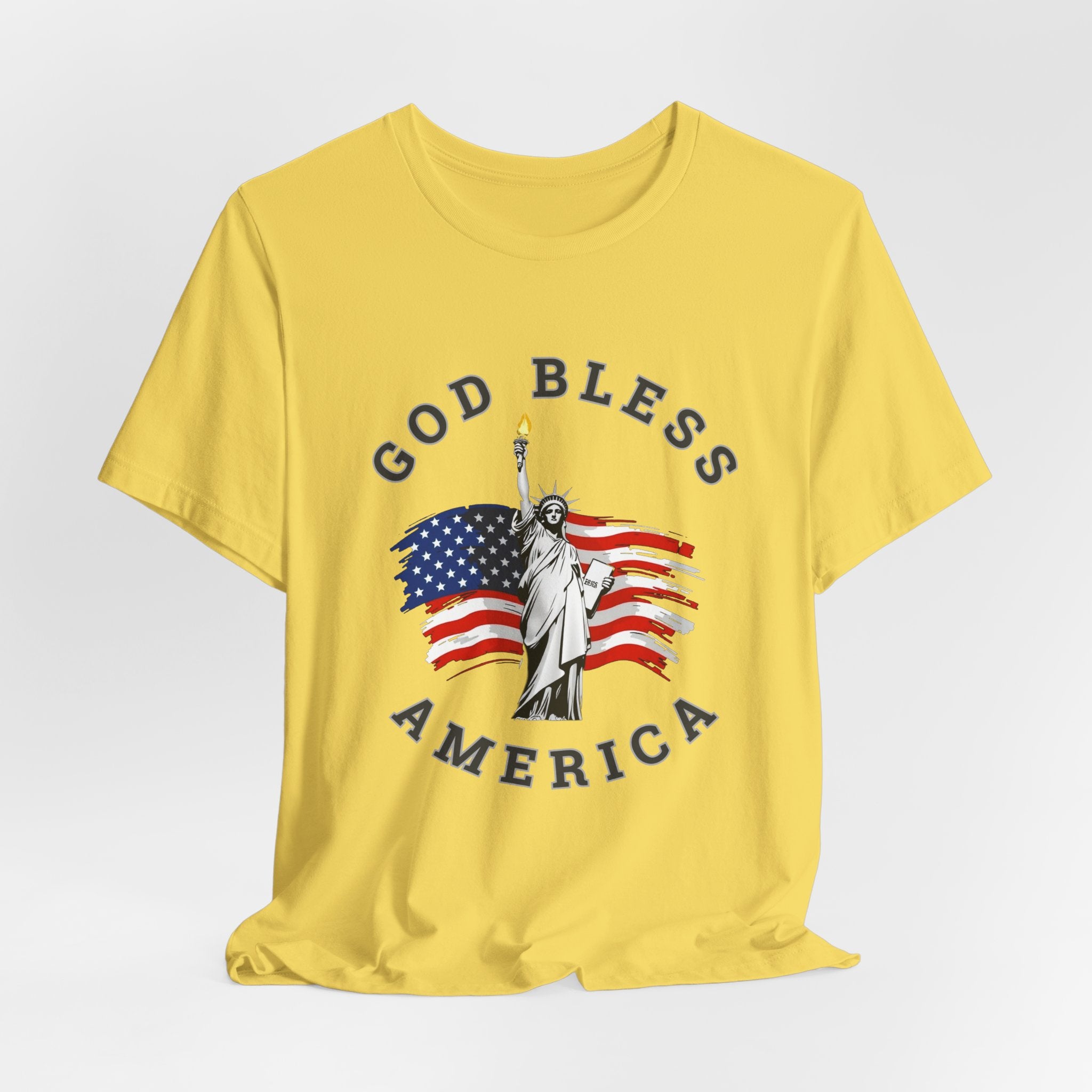 Maze yellow t-shirt with 'God Bless America' graphic featuring the Statue of Liberty and American flag on a white background.