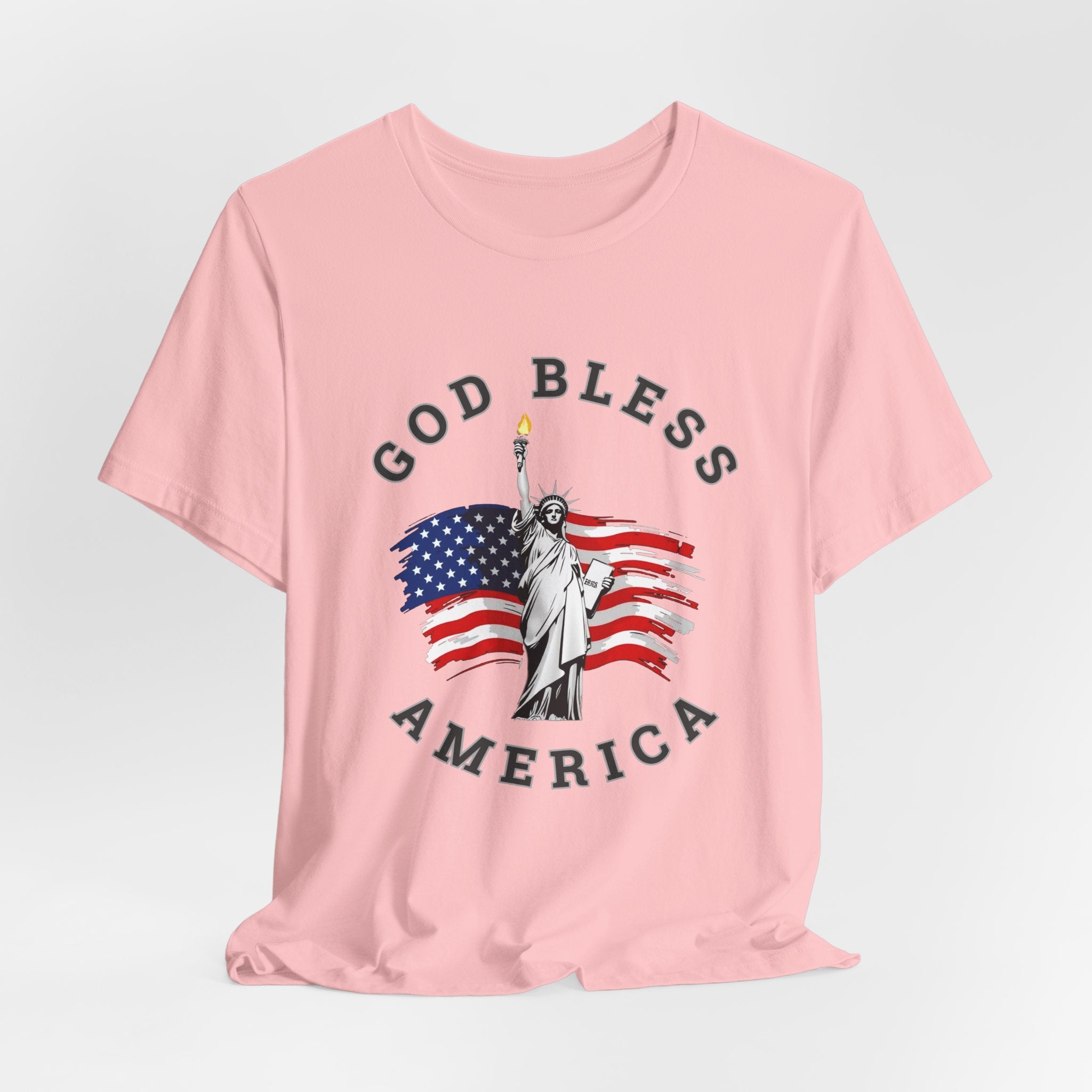 Pink t-shirt with Statue of Liberty and American flag graphic on a light gray background