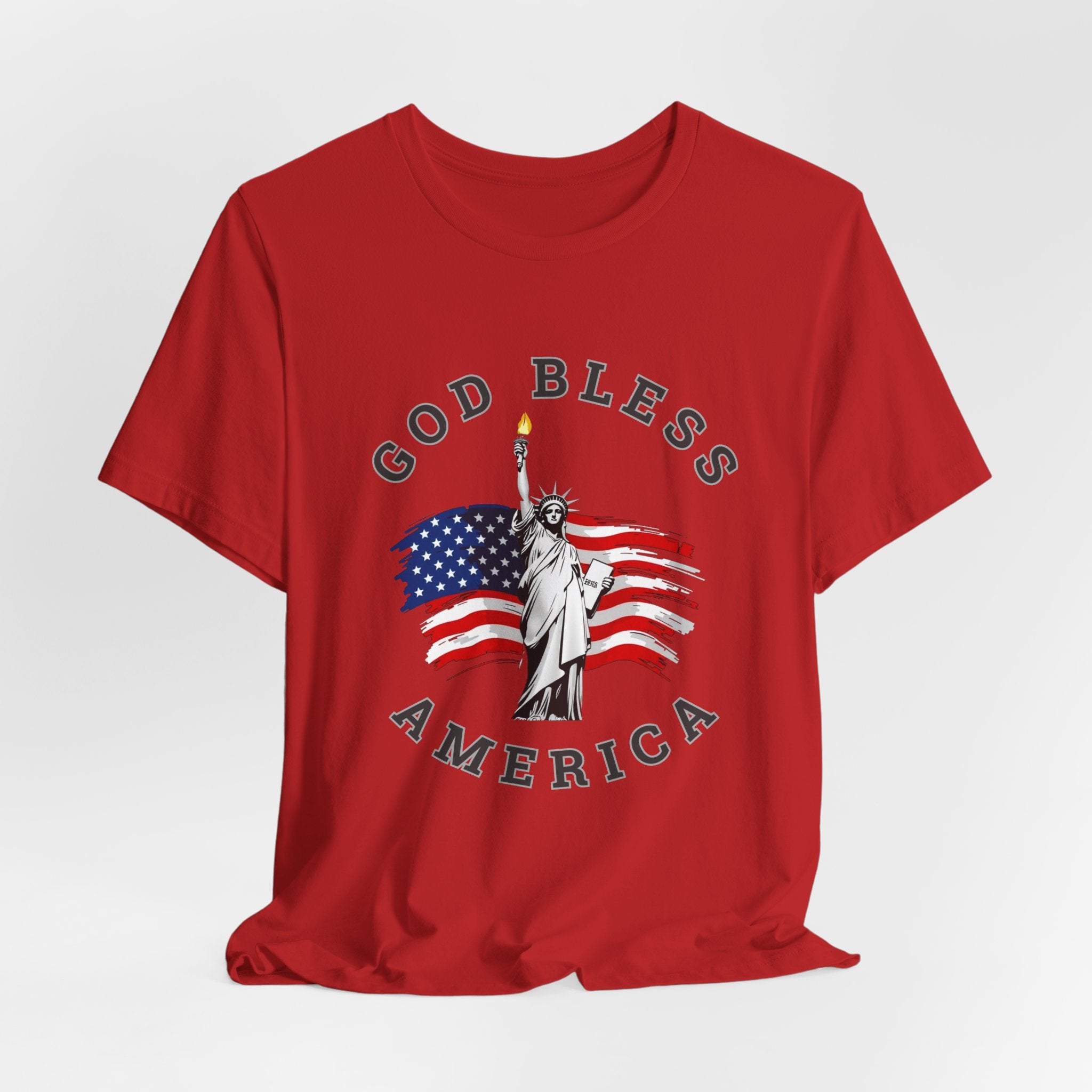 Red t-shirt with 'God Bless America' graphic featuring the Statue of Liberty and American flag on a white background.
