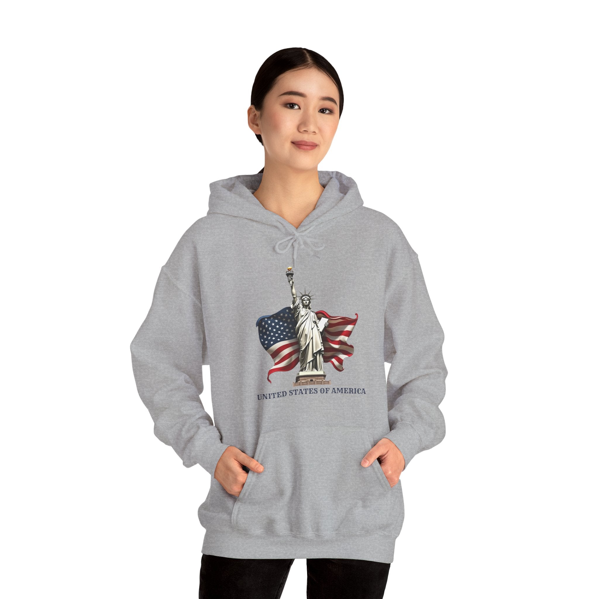 Person wearing a gray hoodie with Statue of Liberty and American flag design on a white background
