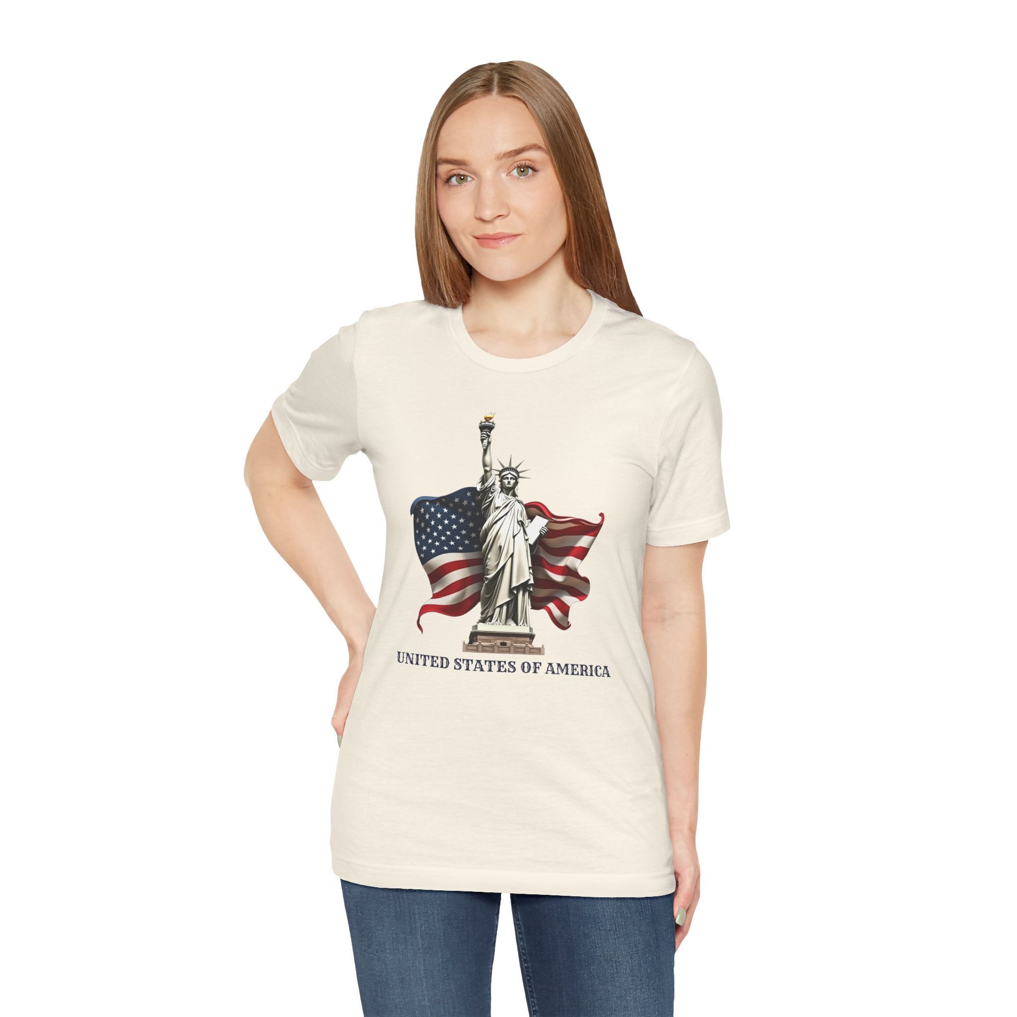 Woman wearing a white t-shirt with a graphic of the Statue of Liberty and American flag on a white background