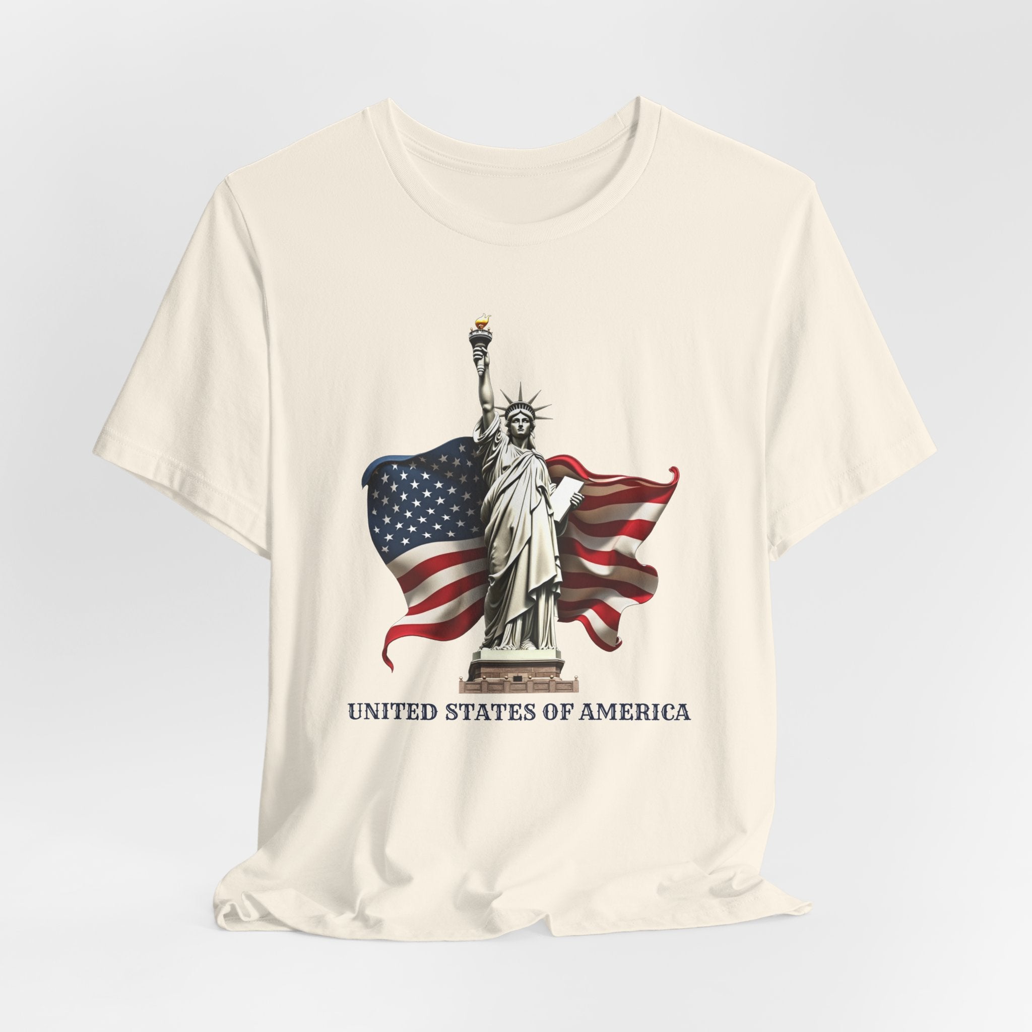 Ivory beige t-shirt with Statue of Liberty and American flag design on a light gray background