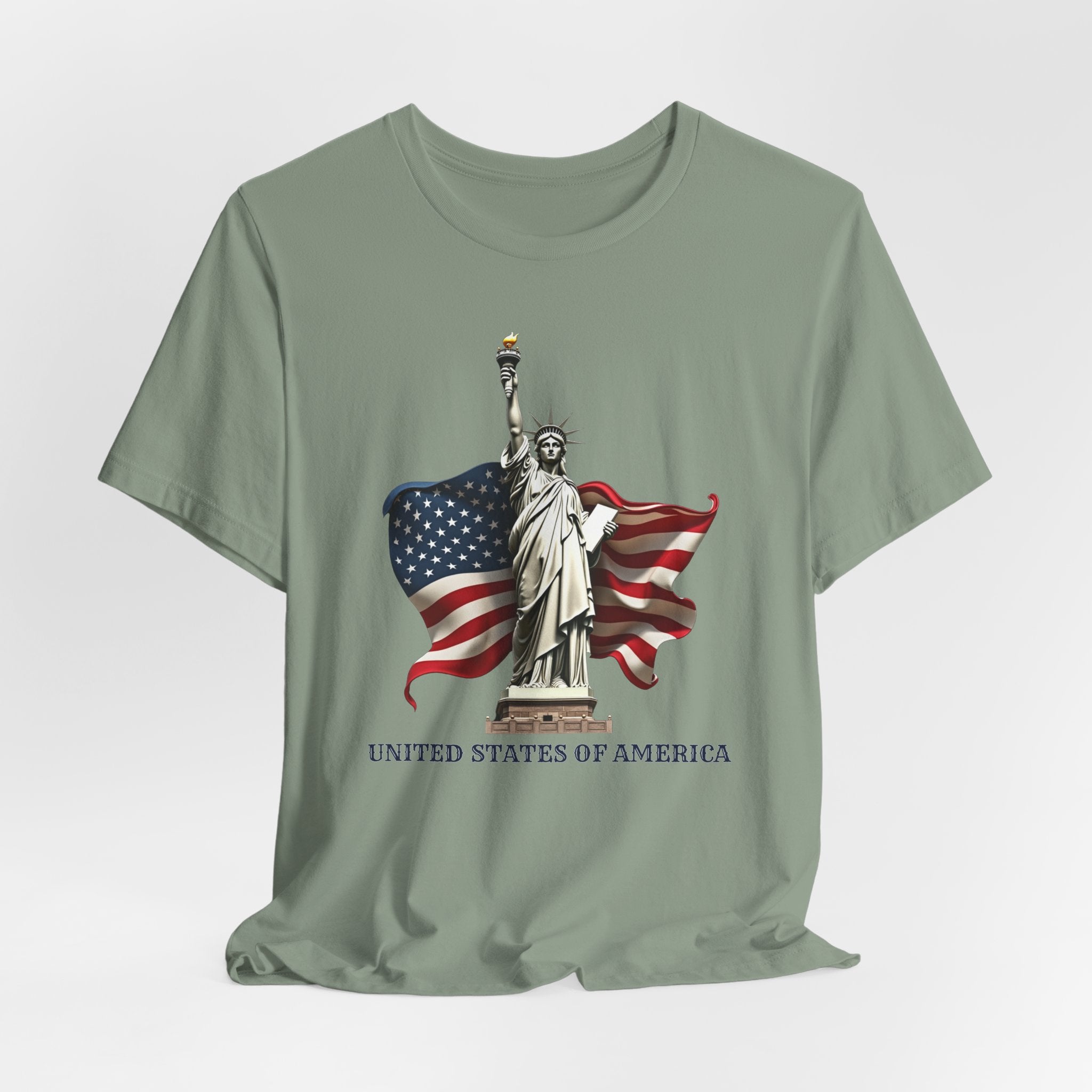 Sage green t-shirt with Statue of Liberty and American flag design on a white background