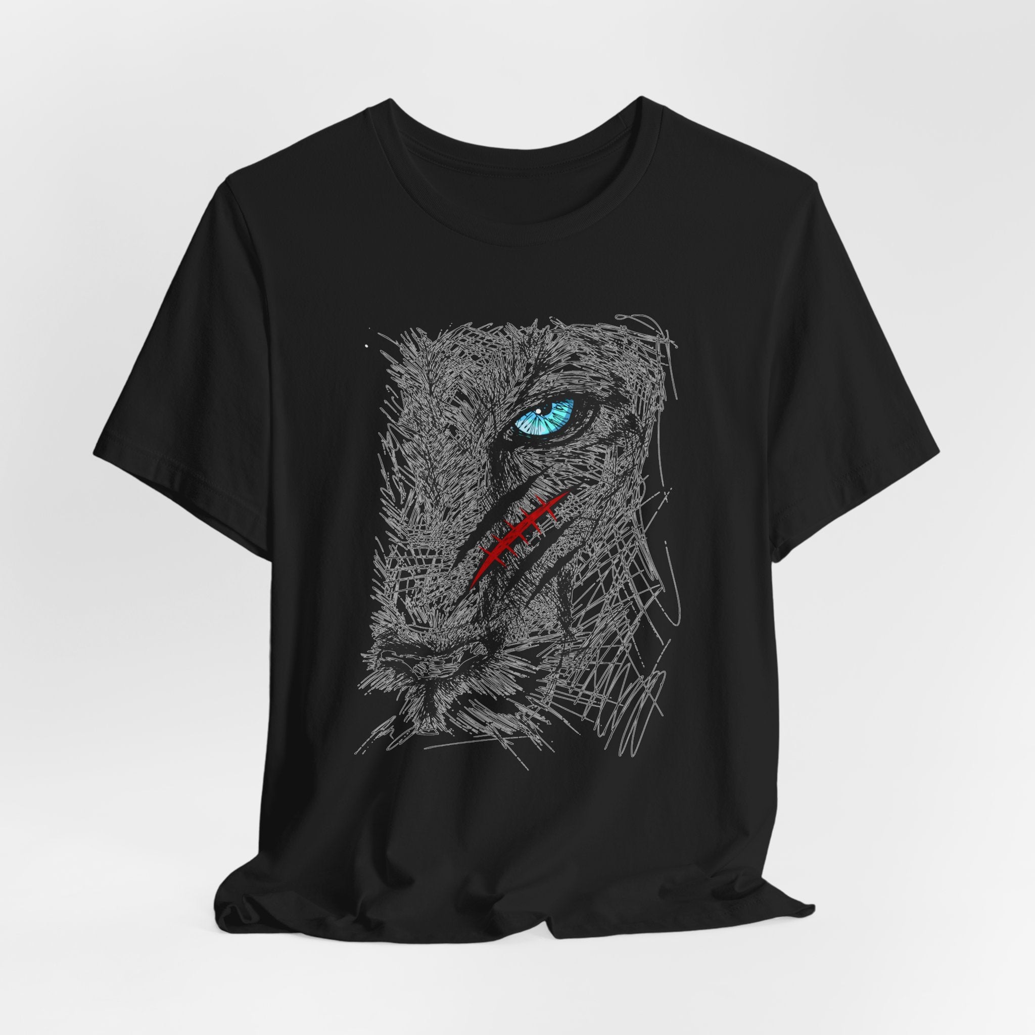 Black t-shirt with a graphic of a wounded lion's face with a blue eye