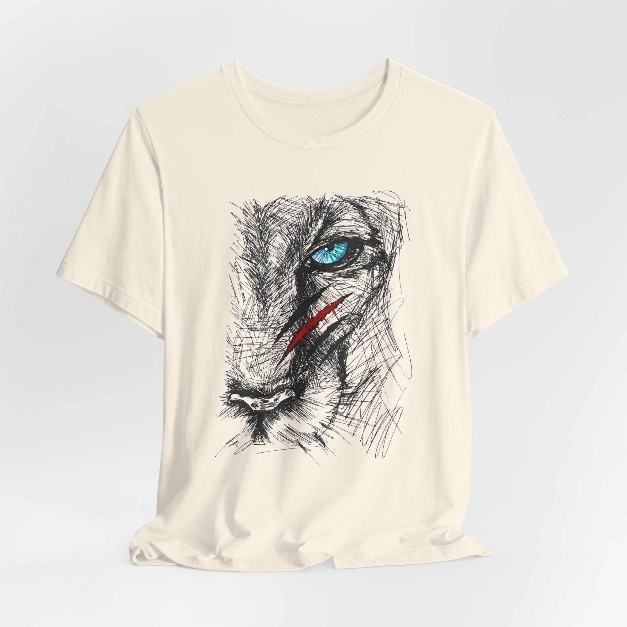 Ivory beige t-shirt with a graphic of a wounded lion's face with a blue eye