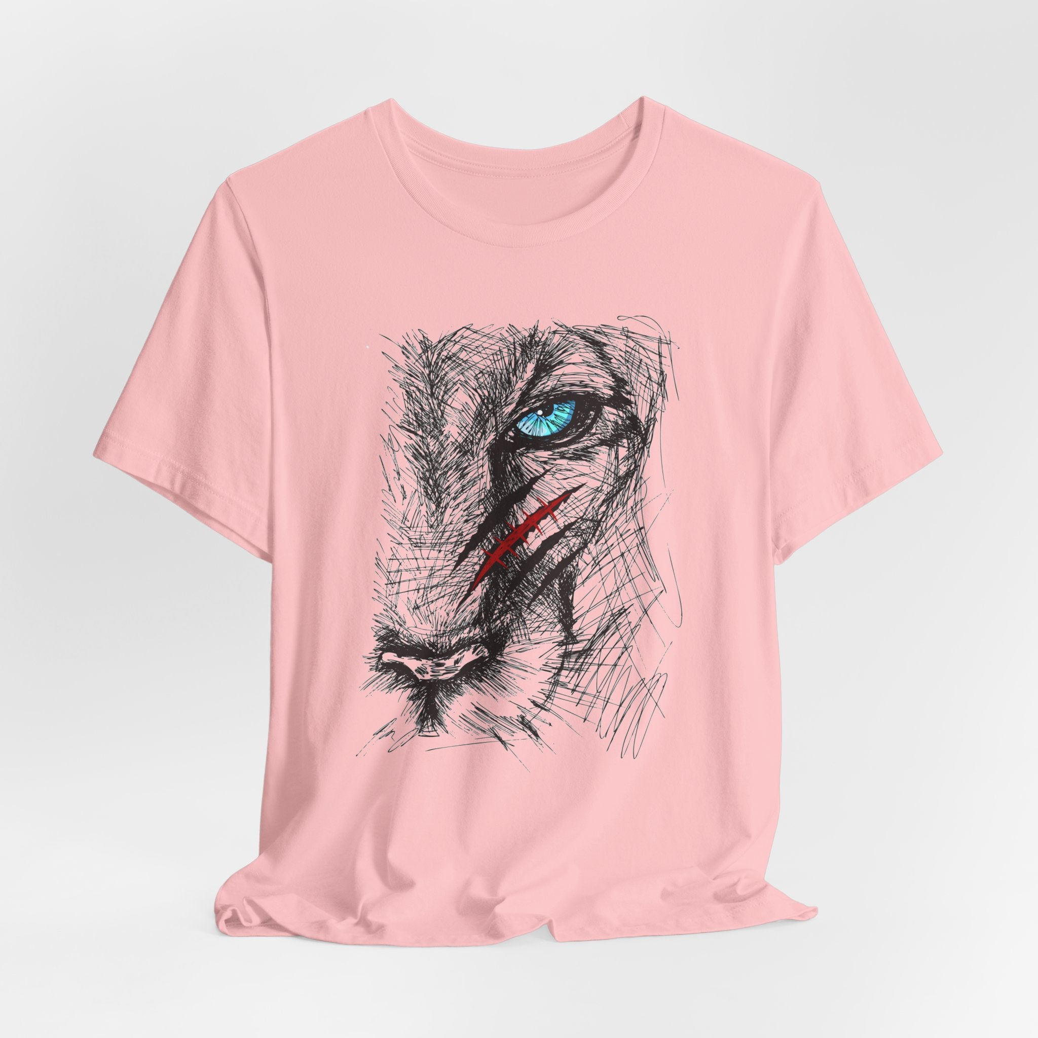 Pink t-shirt with a graphic of a wounded lion's face with a blue eye
