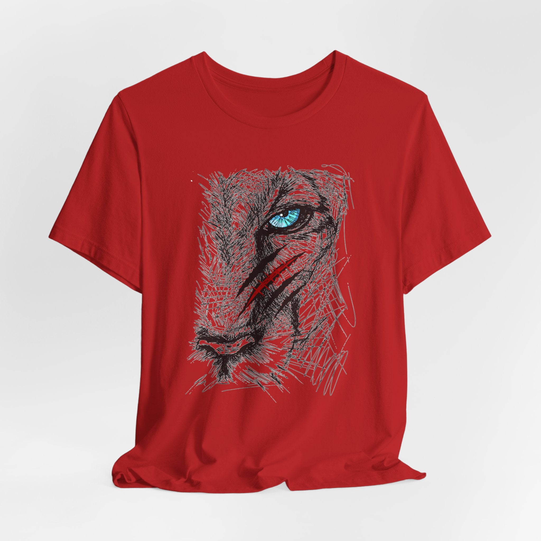 Red t-shirt with a graphic of a wounded lion's face with a blue eye 