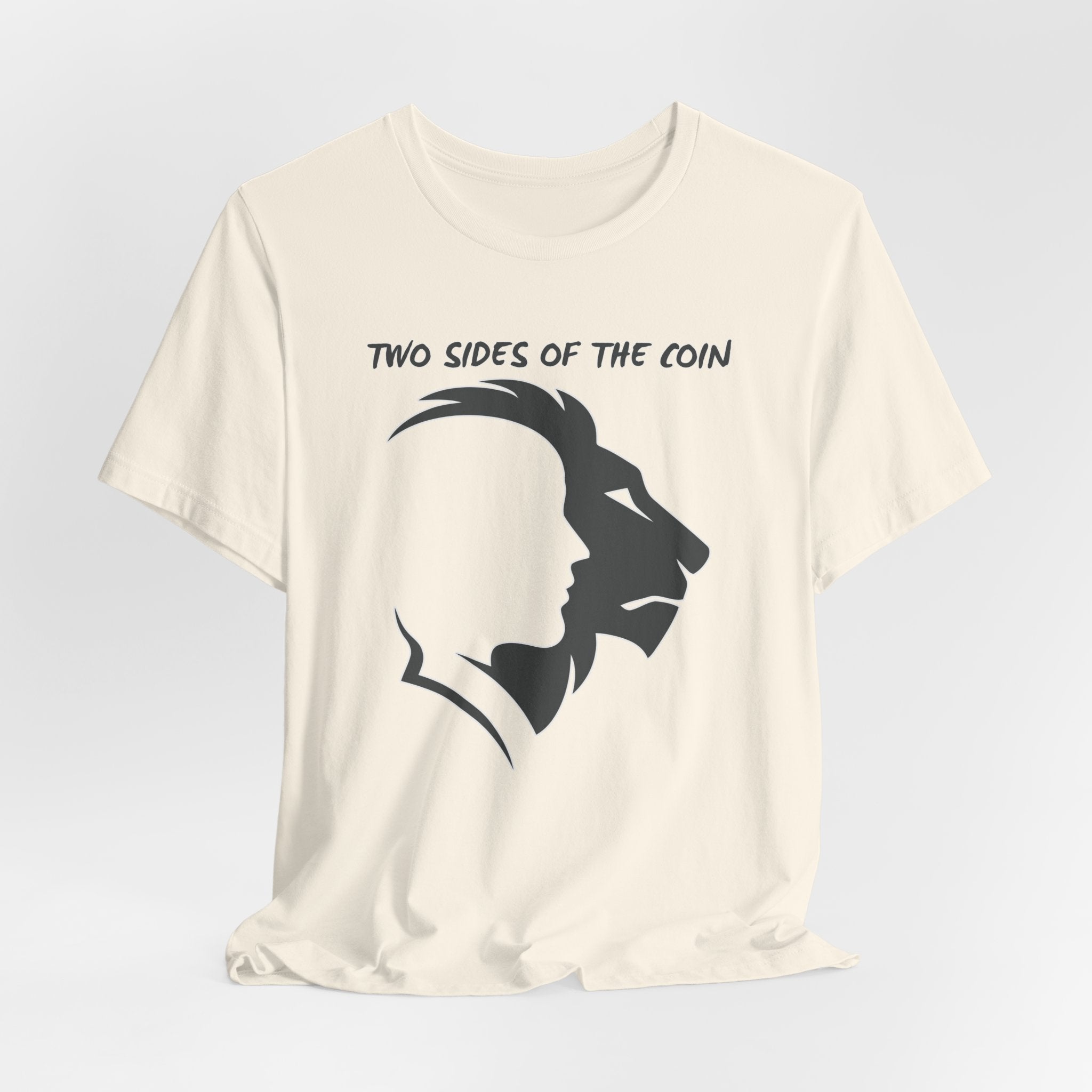 Ivory Beige t-shirt with dark gray graphic of lion and human faces and text 'Two Sides of the Coin' on a light gray background