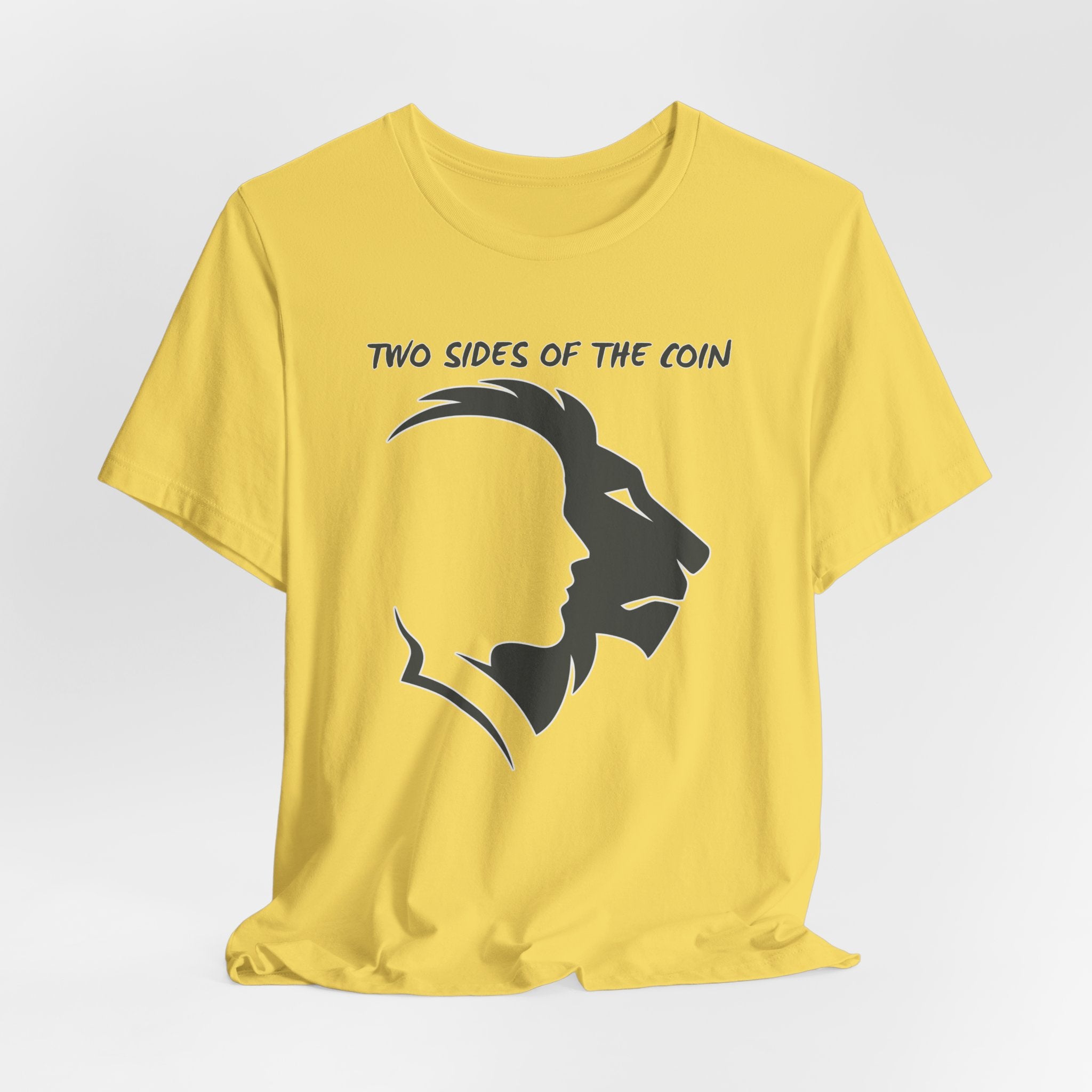 Maze Yellow t-shirt with dark gray graphic of lion and human faces and text 'Two Sides of the Coin' on a light gray background