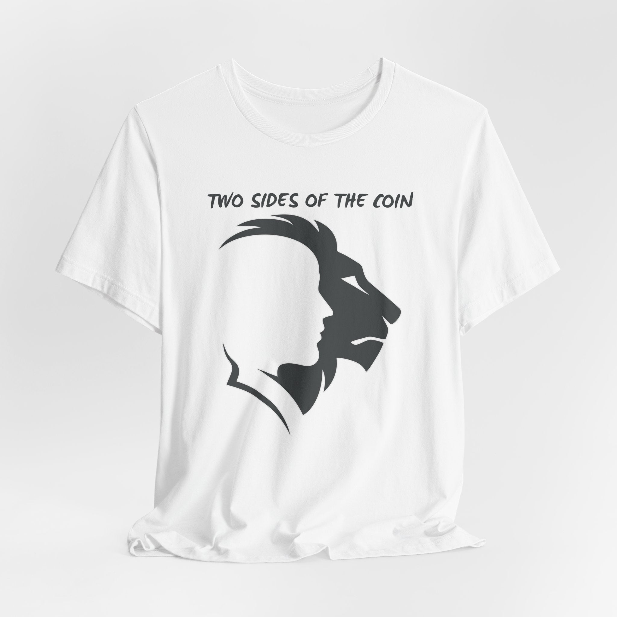 White t-shirt with dark gray graphic of lion and human faces and text 'Two Sides of the Coin' on a light gray background