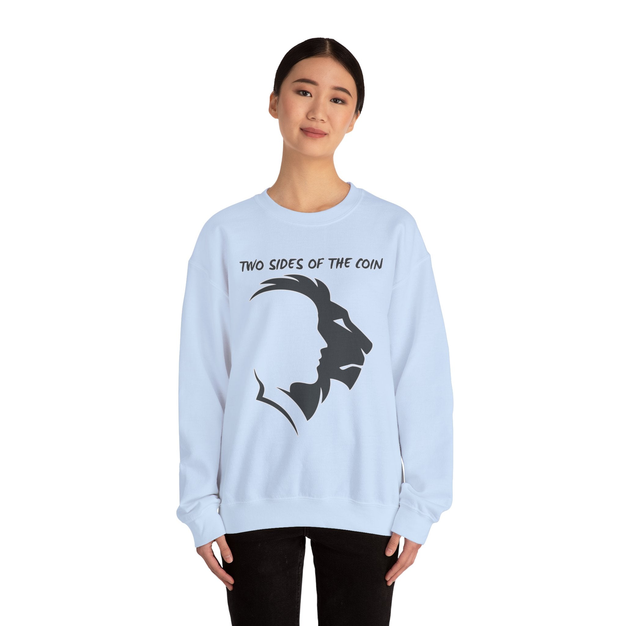 Light blue sweatshirt with lion design and text worn by a person on a white background