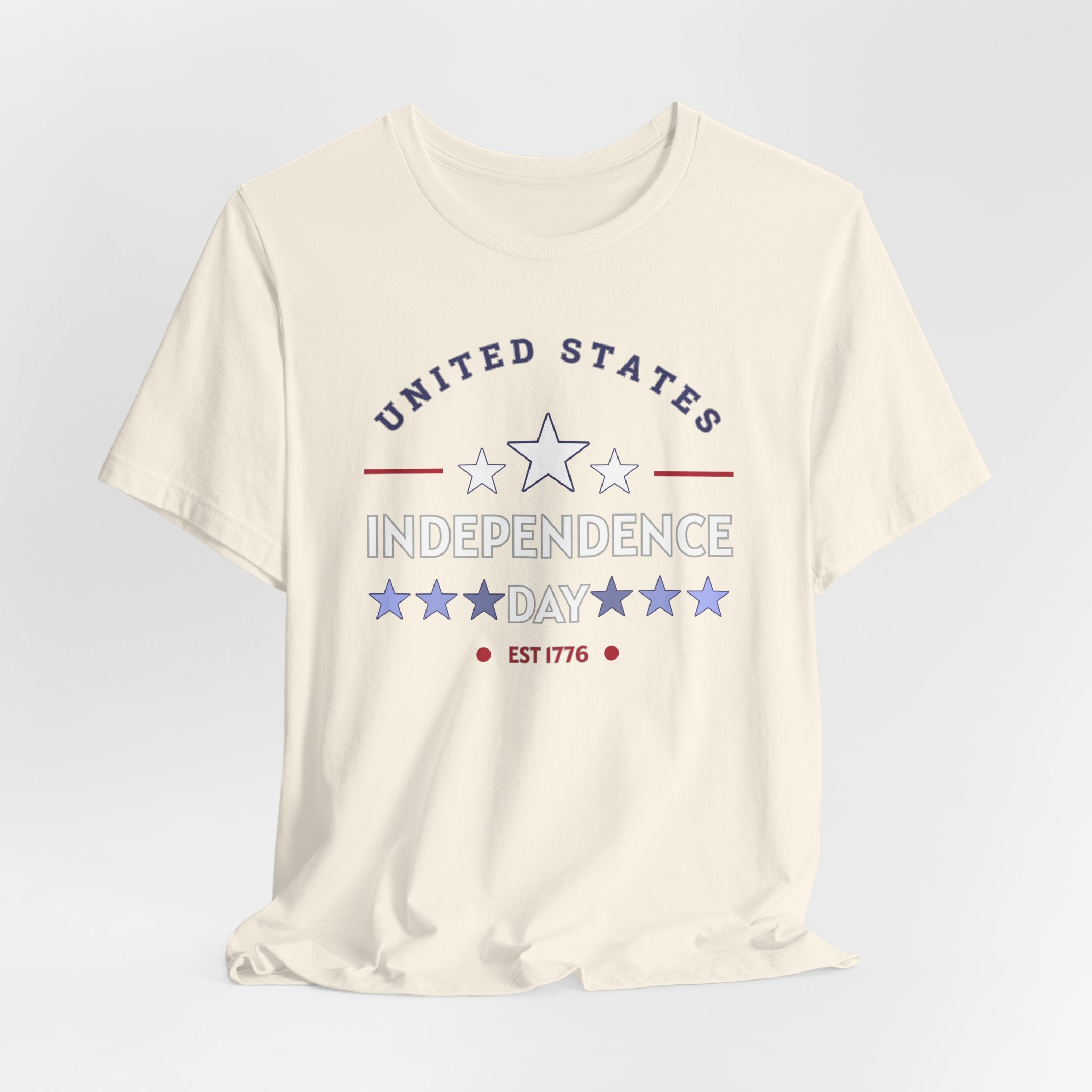 Ivory beige t-shirt with 'United States Independence Day' text and star graphics on a light gray background