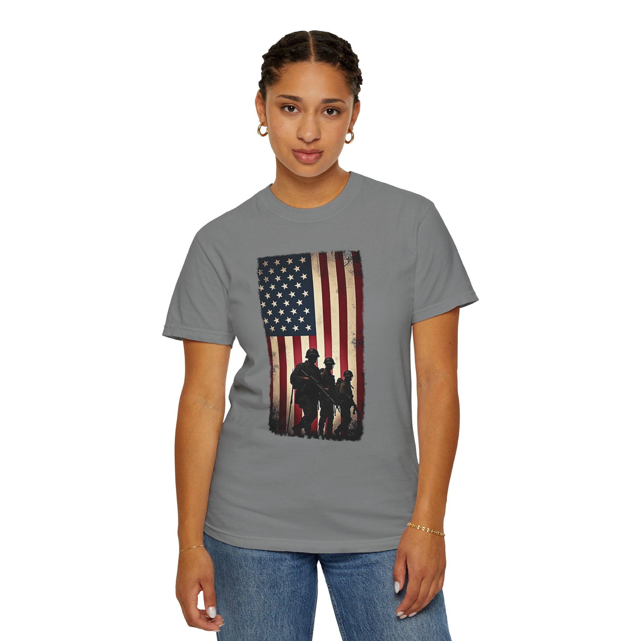 Person wearing a gray t-shirt with an American flag and silhouette design on a white background