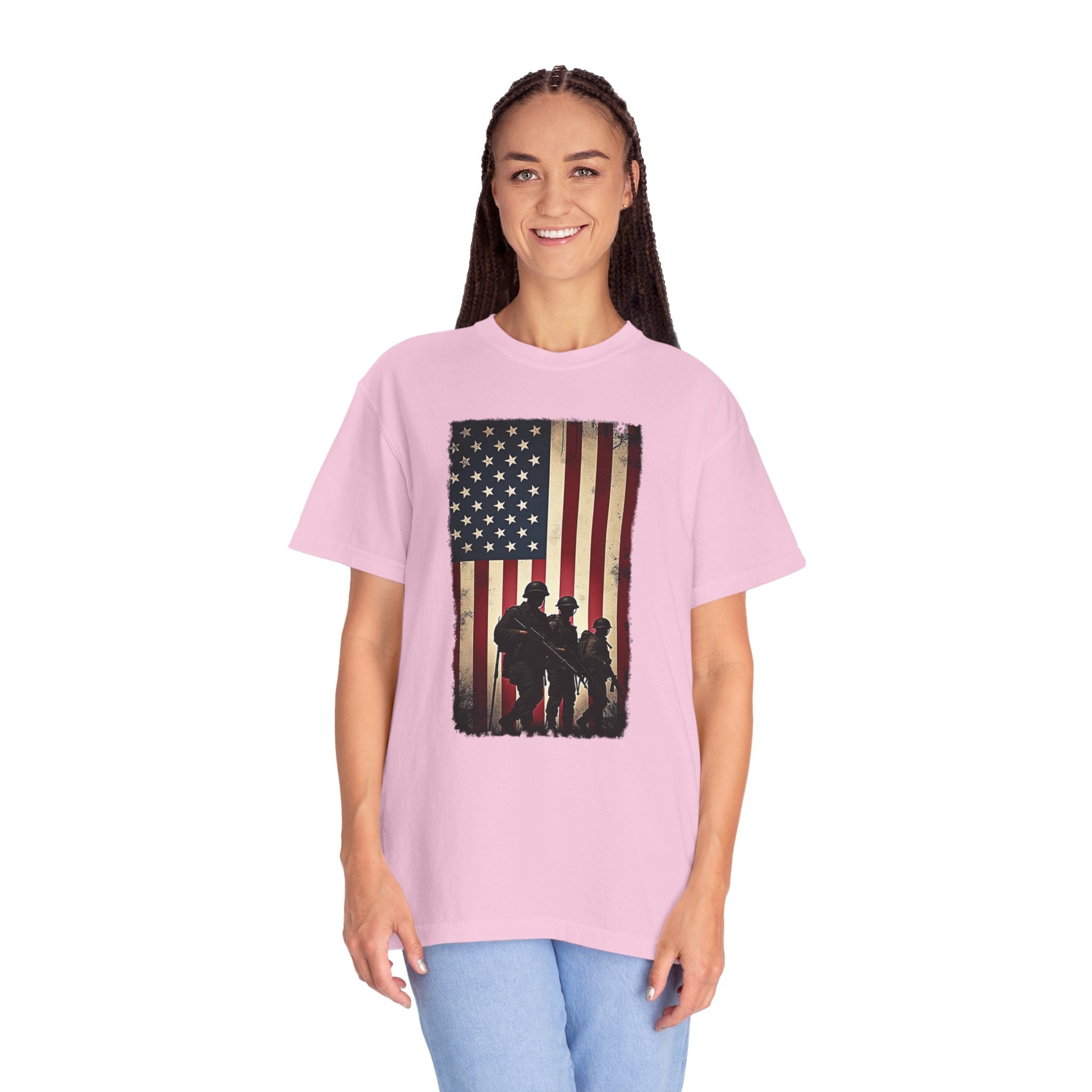 Person wearing a pink t-shirt with an American flag and silhouette design on a white background