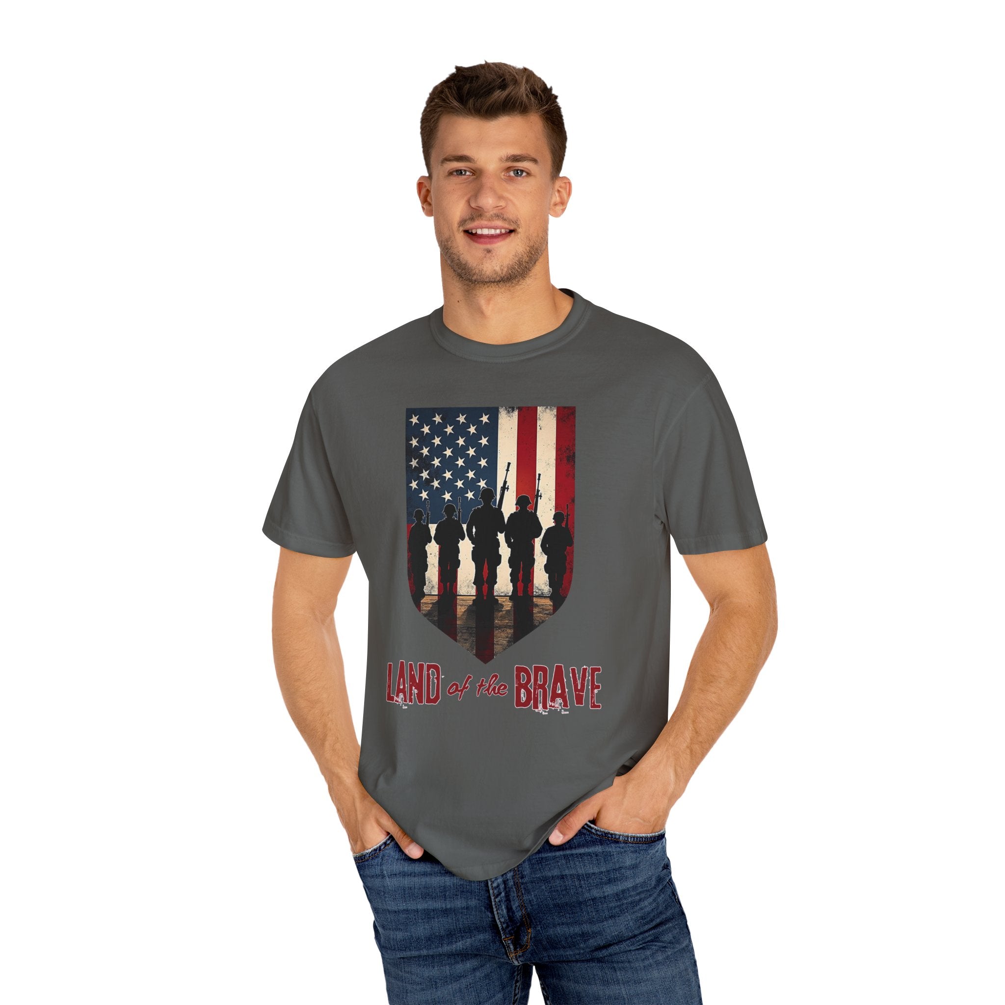 Man wearing a gray t-shirt with an American flag and silhouette design, text 'Land of the Brave' on a white background.