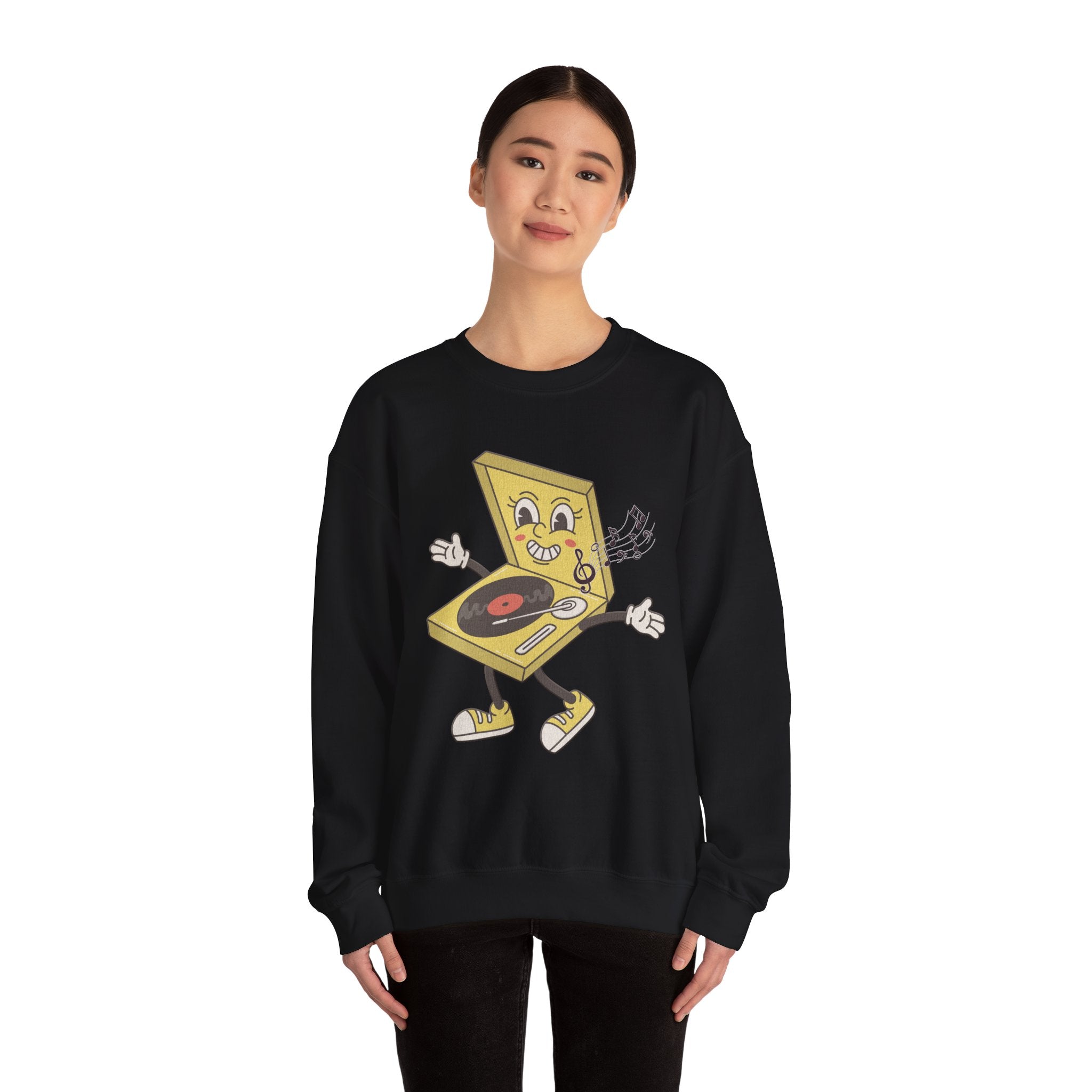 Person wearing a black sweatshirt with a yellow vinyl player graphic and music notes on a white background