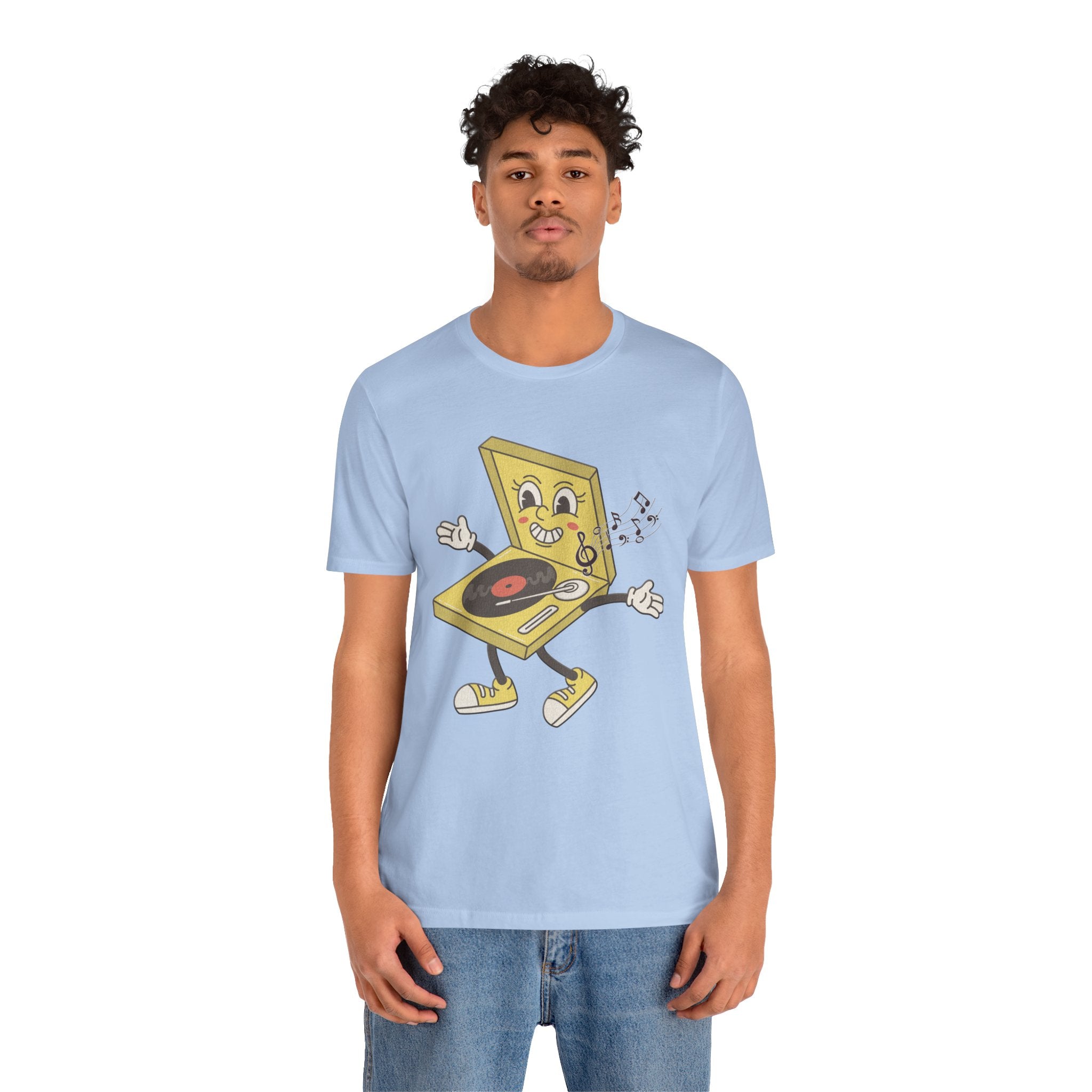 Person wearing a light blue t-shirt with a cartoon graphic on a white background