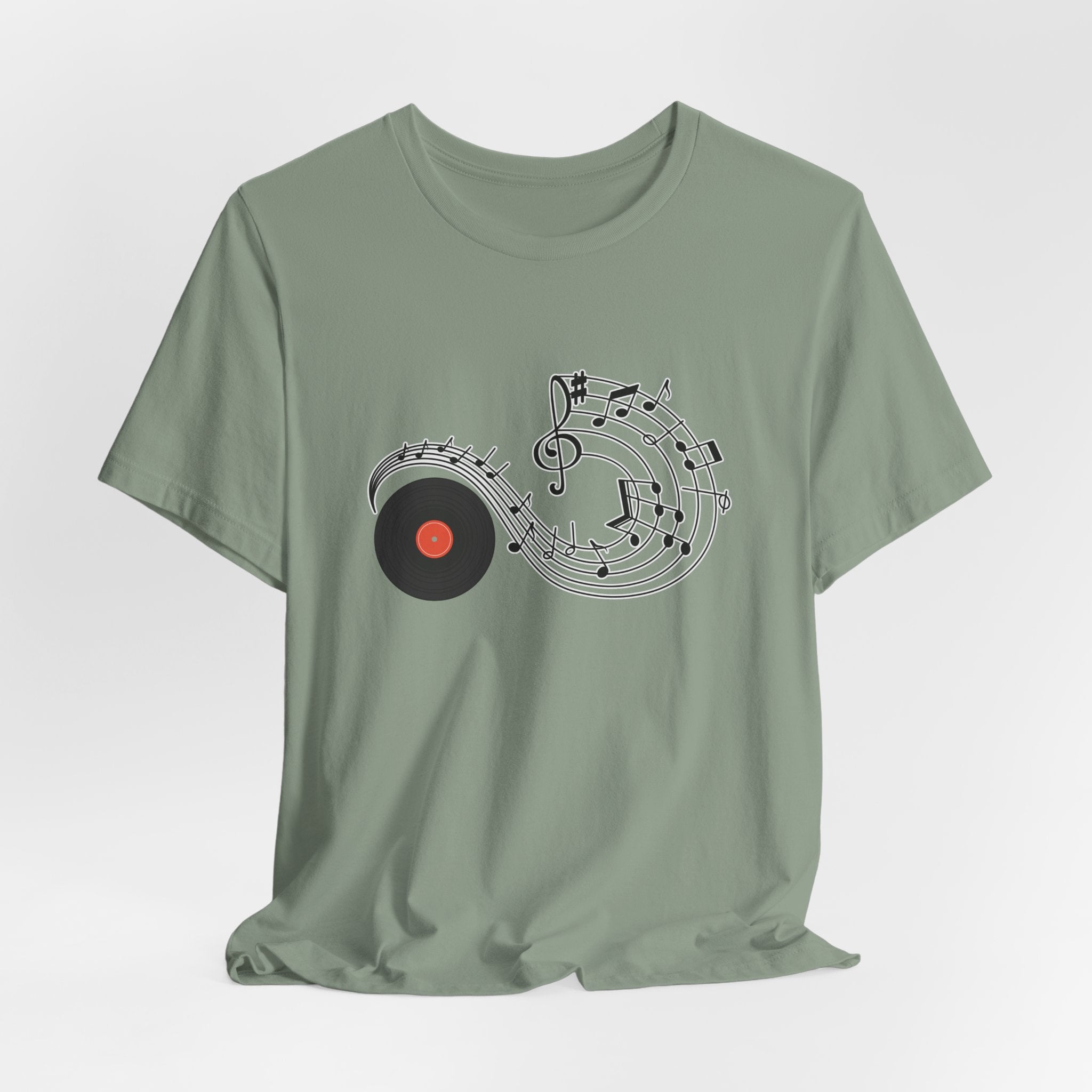 Sage green t-shirt with music-themed design on a light gray background