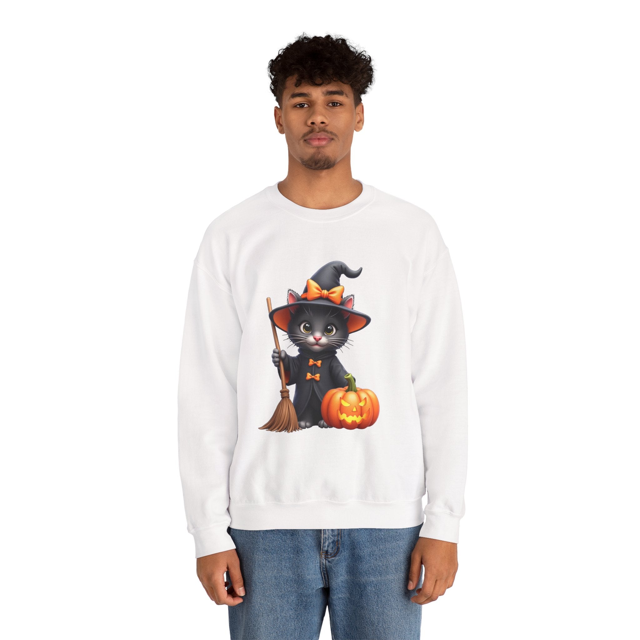 Person wearing a white sweatshirt with a Halloween-themed design featuring a black cat in a witch hat, broom, and pumpkin.