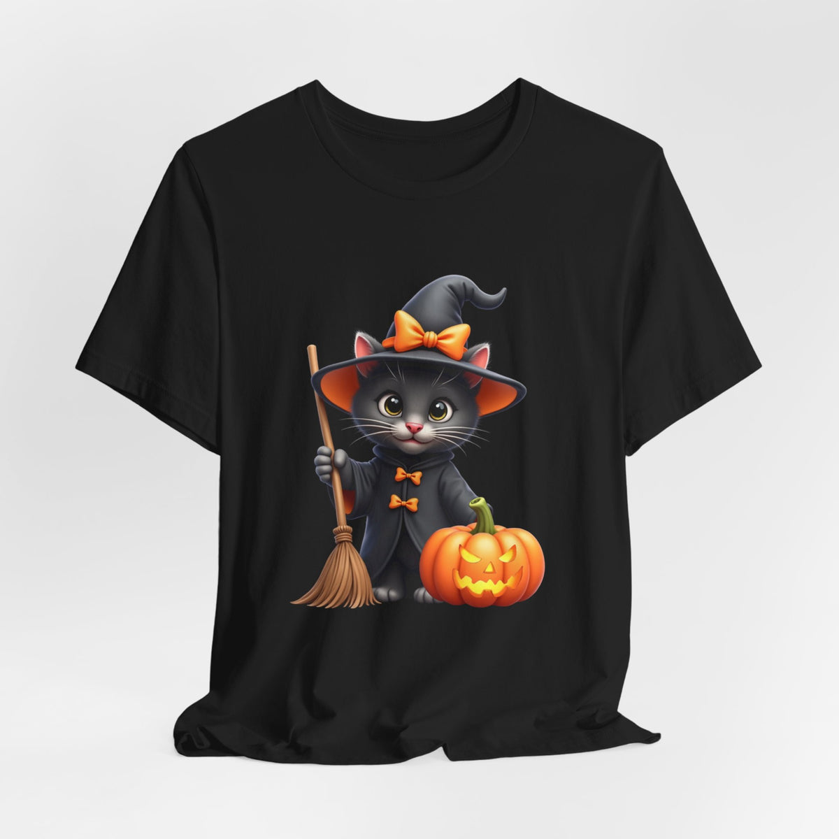 Black t-shirt with a Halloween-themed design of a cat in a witch costume holding a pumpkin and broomstick.