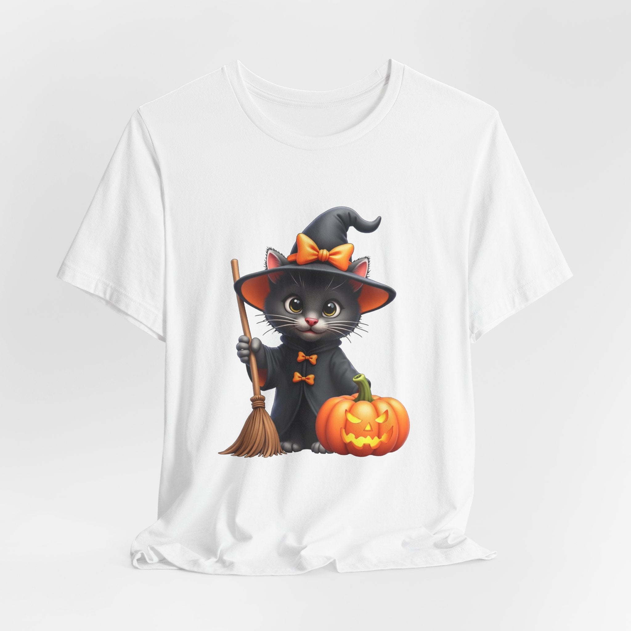 White t-shirt with a Halloween-themed design of a black cat in a witch costume holding a broom and pumpkin.